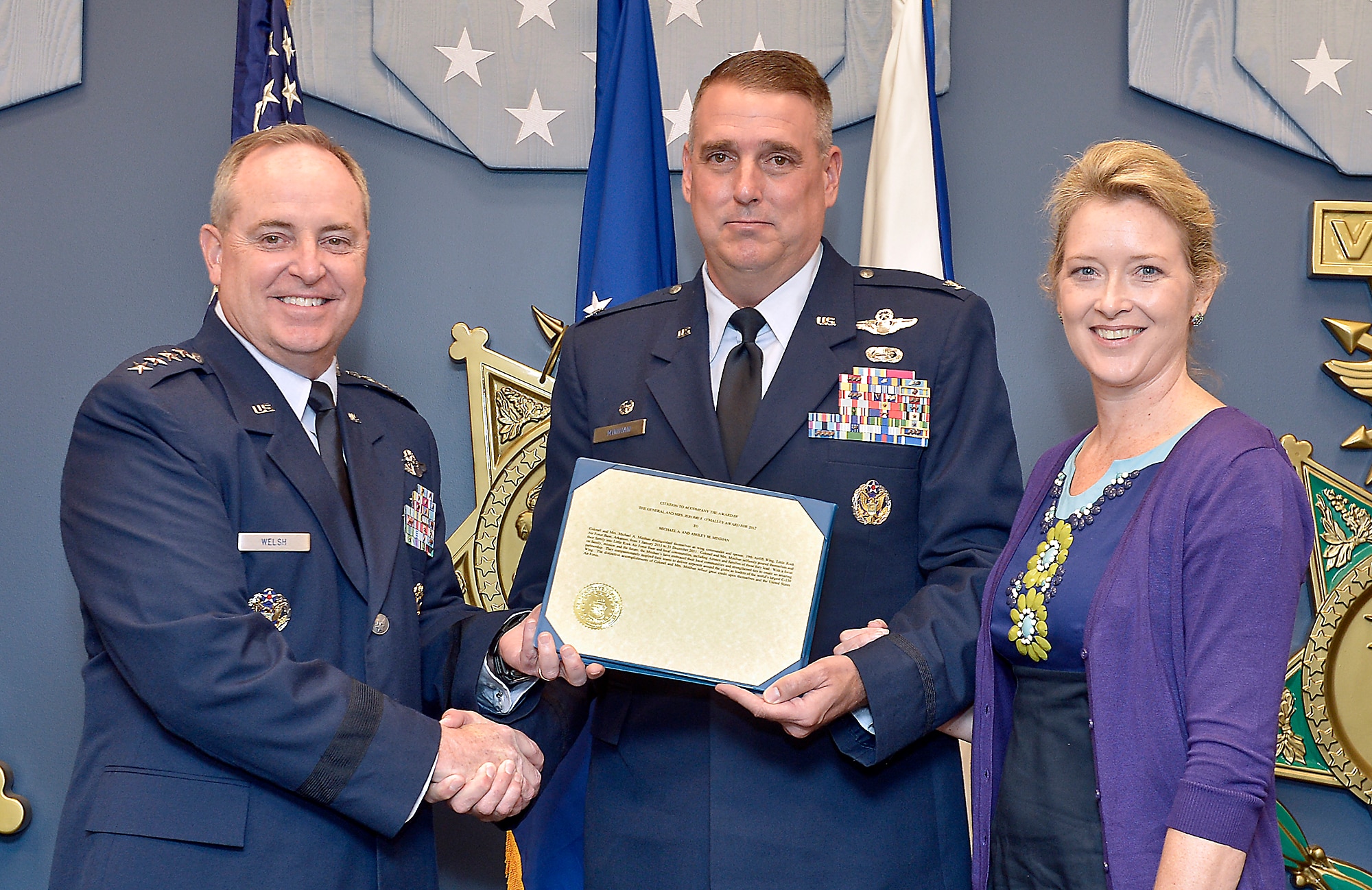 Air Force Chief of Staff Gen. Mark A. Welsh III presents the 2012 General Jerome F. O'Malley and Diane O'Malley Award to Col. Michael Minihan and his wife, Ashley, during a ceremony at the Pentagon, Oct. 24, 2012. The Minihans earned the award for their time in command at Little Rock Air Force Base, Ark. The annual award recognizes the wing commander and spouse team whose contributions to the nation, Air Force, and local community best exemplify the highest ideals and positive leadership of a military couple in a key Air Force position. (U.S. Air Force photo/Michael J. Pausic)