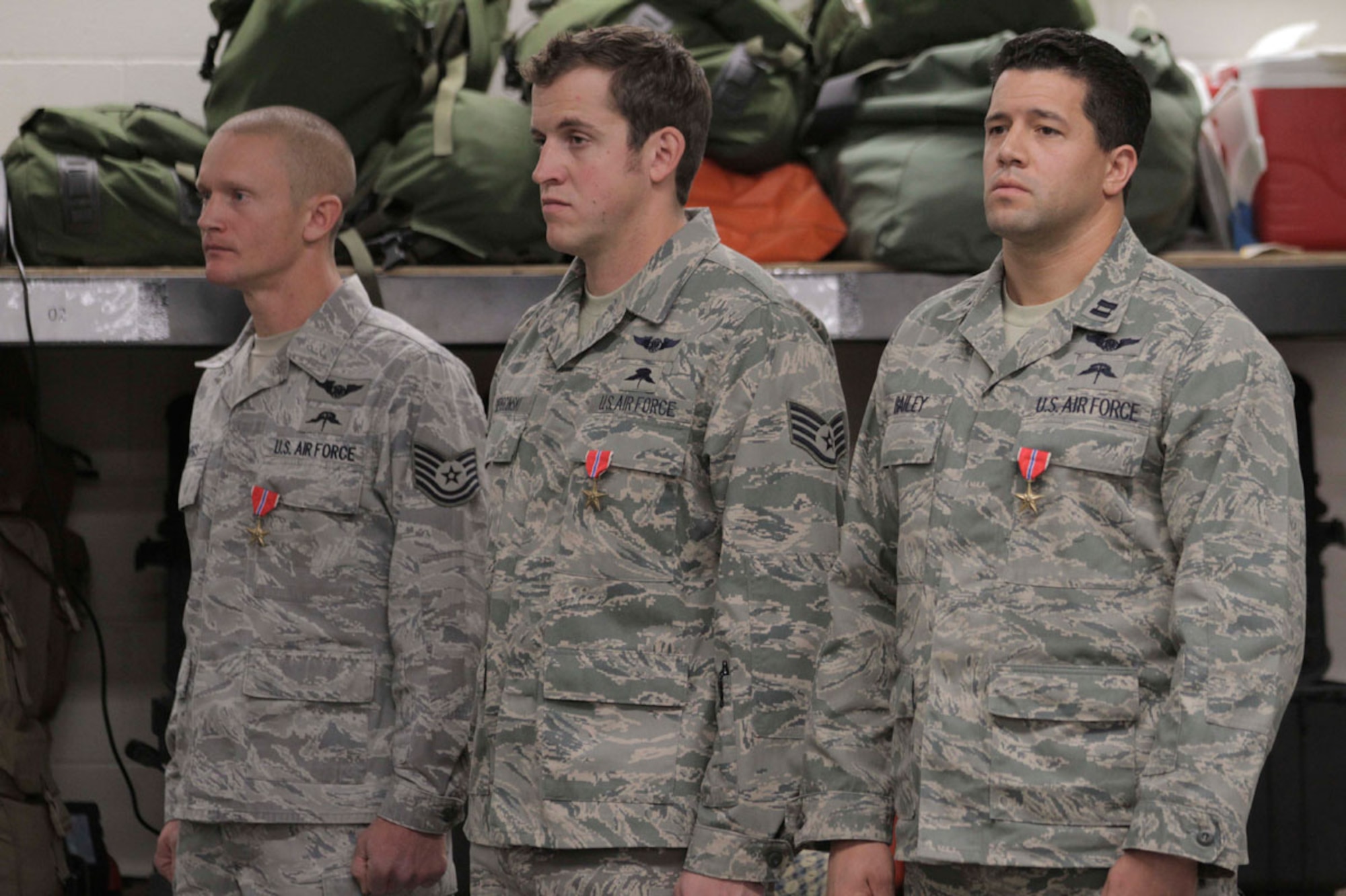 Tech. Sgt. Shane J. Hargis, Air Force Staff Sgt. Theodore M. Sierocinski and Capt. Koaalii C. Bailey stand during a Oct. 13 ceremony after they received the Bronze Star Medal with Valor device. (Alaska National Guard photo/Air Force Maj. Guy Hayes)
