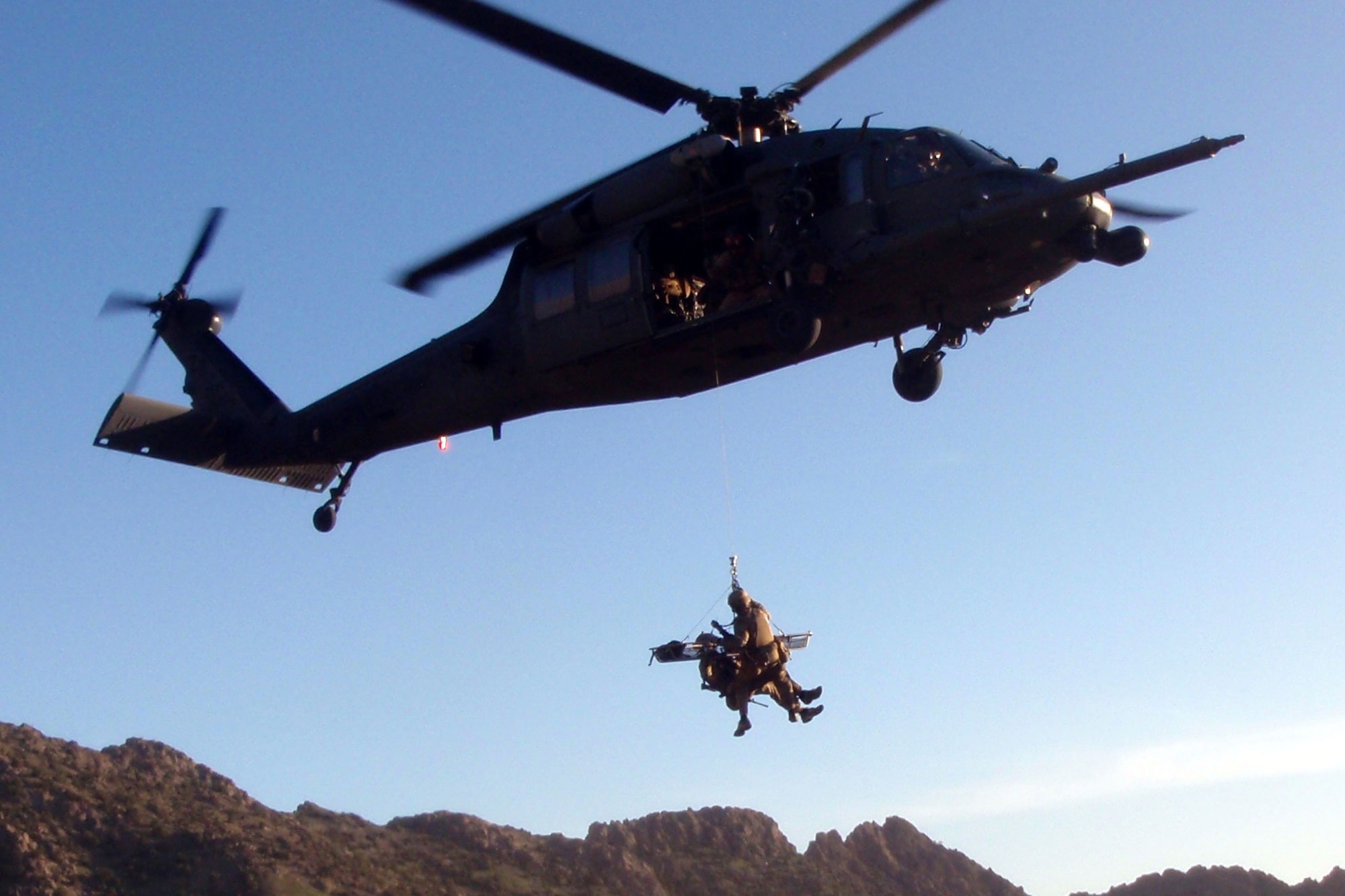 Air Force Maj. Jesse Peterson and Tech. Sgt. Shane Hargis, 83rd Expeditionary Rescue Squadron, practice a hoist mission, April 22, 2011, the day before they were called upon to recover pilots of a downed helicopter. (U.S. Air Force photo/Staff Sgt. Bill Cenna)