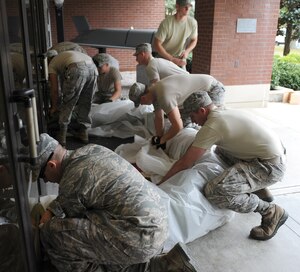 U.S. Airmen from the 633rd Civil Engineer Squadron move sandbags to various buildings to prevent flooding at Langley Air Force Base, Va., Oct. 26, 2012. Both Langley and Fort Eustis are preparing for Hurricane Sandy, which is expected to reach the Virginia border by 2 a.m., Oct. 29, 2012. (U.S. Air Force photo by Airman 1st Class Teresa Aber/Released)