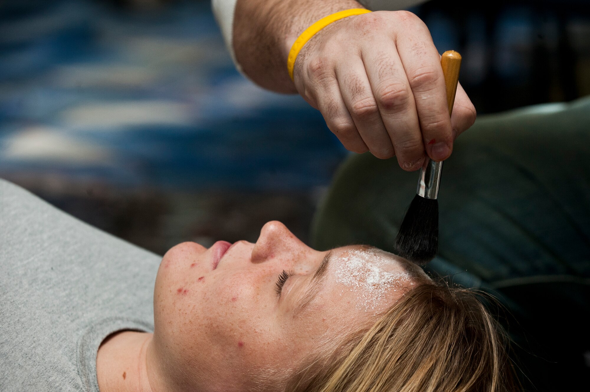 Airman 1st Class Dallas Ockey, 57th Operations Support Squadron air traffic controller, gets makeup applied to her face by a moulage artist during the 2012 Triennial Emergency Preparedness Exercise at McCarran International Airport Oct. 24, 2012, in Las Vegas.  One of the exercise objectives is to enhance coordination between the airport, public, and private responding agencies. (U.S. Air Force photo by Airman 1st Class Jason Couillard)