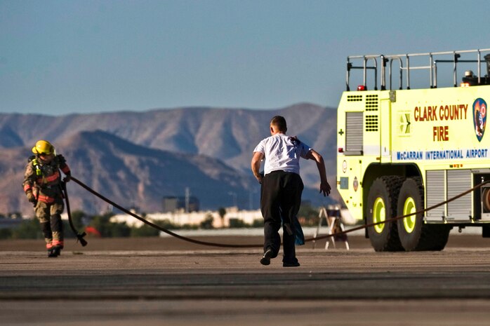 An Airman from Nellis Air Force Base, Nev. runs to safety after a simulated plane crash during the 2012 Triennial Emergency Preparedness Exercise conducted by the Clark County Department of Aviation at McCarran International Airport Oct. 24, 2012, in Las Vegas, Nev. This realistic exercise helps provide police, fire and ambulance agencies the opportunity to participate in a mass casualty exercise for emergency response training and evaluations. (U.S. Air Force photo by Senior Airman Daniel Hughes)