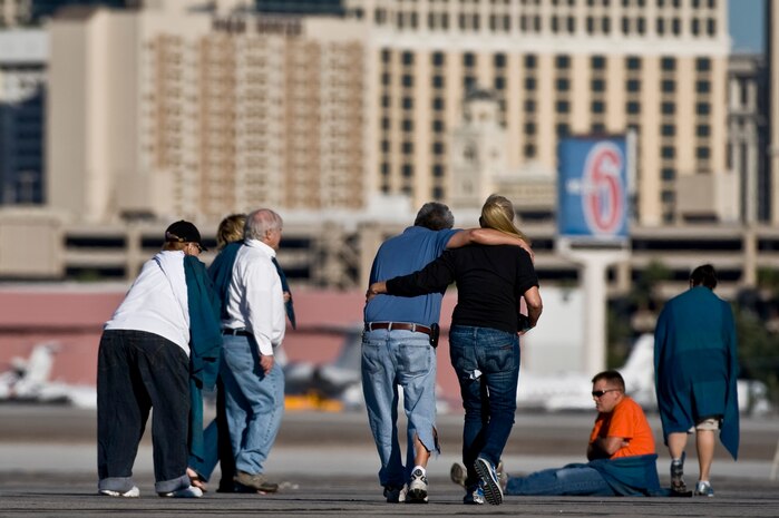 Nellis Airmen and volunteers walk to safety during the 2012 Triennial Emergency Preparedness Exercise conducted by the Clark County Department of Aviation at McCarran International Airport Oct. 24, 2012, in Las Vegas, Nev. More than 100 volunteers acted as casualties for the mass casualty exercise. (U.S. Air Force photo by Senior Airman Daniel Hughes)