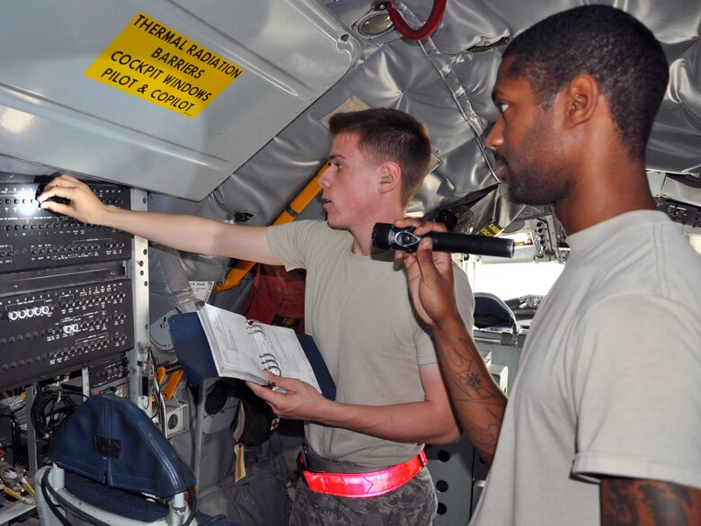 Staff Sgt. Carlton Creary looks on as Airman 1st Class Justin Kapsch pulls out the circuit breakers on a KC-135 Stratotanker at McConnell Air Force Base, Kan., Oct. 22, 2012.  The circuit breakers on the aircraft are pulled for safety and to save battery power when the jet isn't being flown.  The Airmen, both crew chiefs assigned to the 931st Aircraft Maintenance Squadron, are part of a team that accomplishes a lengthy checklist of items to ensure McConnell's fleet of tankers stay mission ready.  (U.S. Air Force photo by 1st Lt. Zach Anderson)