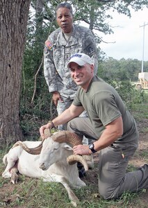 Capt. Vance Flowers, a wounded warrior who serves with U.S. Army North, along with Maj. Gen. Adolph McQueen Jr., deputy commanding general for support, U.S. Army North, show off the white Texas Dall sheep that Flowers bagged Oct. 11 during a wounded warrior hunt at a private central Texa  game ranch. Flowers lost his right leg below the knee after an improvised-explosive device detonation in Iraq in 2007.
Photo by Staff Sgt. Keith Anderson