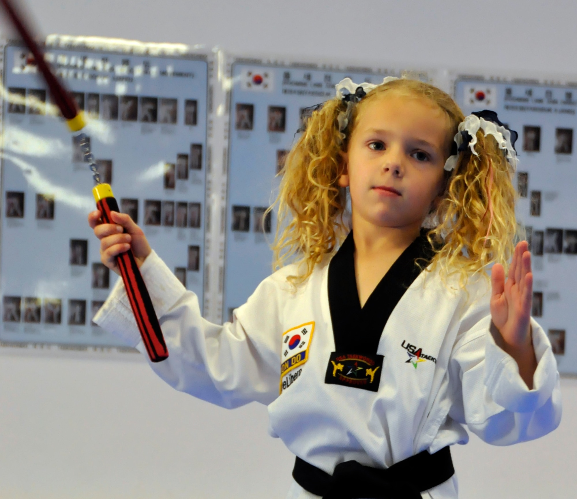 Sidney DeLibero, daughter of a 446th Airlift Wing Reservist, practices with nunchucks at a taekwondo school in Edgewood, Wash., Oct. 17. DiLibero became the world's youngest taekwondo black belt, at age 6, Sept. 20. (U.S. Air Force Photo/Staff Sgt. Rachael Garneau)