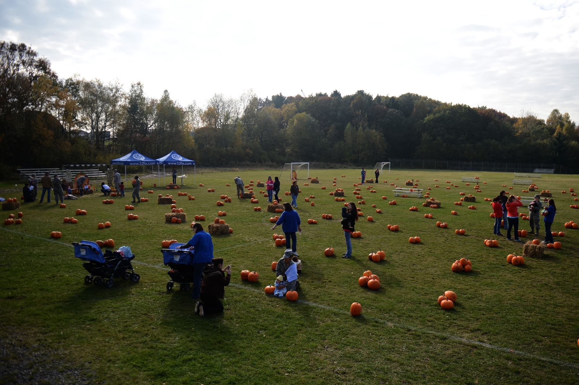 SPANGDAHLEM AIR BASE, Germany – Families search for the perfect pumpkin in a soccer field near the child development center during a pumpkin patch event Oct. 25, 2012.  Bringing holiday traditions on base is just one of the ways the 52nd Force Support Squadron Airman and Family Services Flight support the 52nd Fighter Wing community. (U.S. Air Force photo by Airman 1st Class Gustavo Castillo/Released)  