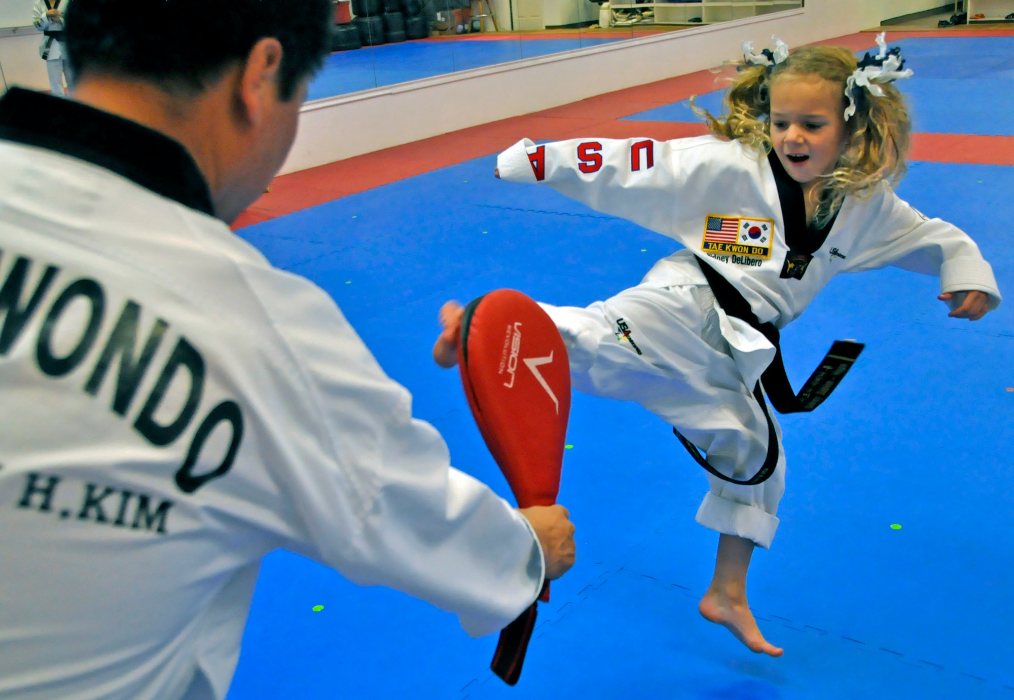 Sidney DeLibero, daughter of a 446th Airlift Wing Reservist, practices her kick at a taekwondo school in Edgewood, Wash., Oct. 17. DiLibero became the world's youngest taekwondo black belt at 6 years old Sept. 20, according to the World Taekwondo Headquarters in South Korea. (U.S. Air Force Photo/Staff Sgt. Rachael Garneau)
