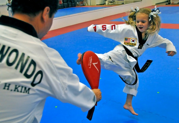 Sidney DeLibero, daughter of a 446th Airlift Wing Reservist, practices her kick at a taekwondo school in Edgewood, Wash., Oct. 17. DiLibero became the world's youngest taekwondo black belt at 6 years old Sept. 20, according to the World Taekwondo Headquarters in South Korea. (U.S. Air Force Photo/Staff Sgt. Rachael Garneau)