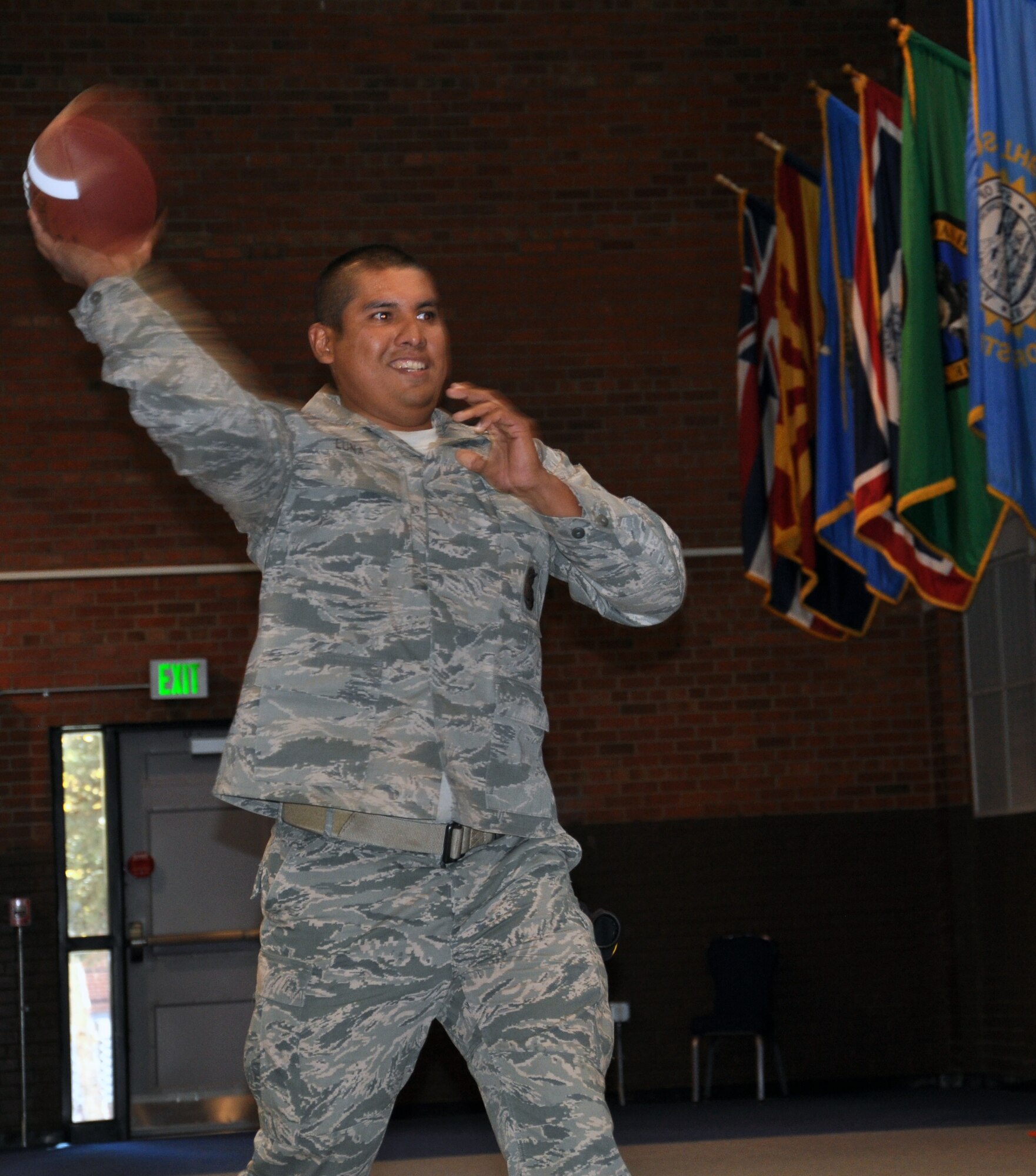 Staff Sgt. Ernie Luna, 90th Security Forces Tactical Response Force, throws a football into a target at the Fall Hall Community Center Oct. 18 during the Domestic Violence Awareness Month’s confidence course competition. (U.S. Air Force photo by Senior Airman Dan Gage)