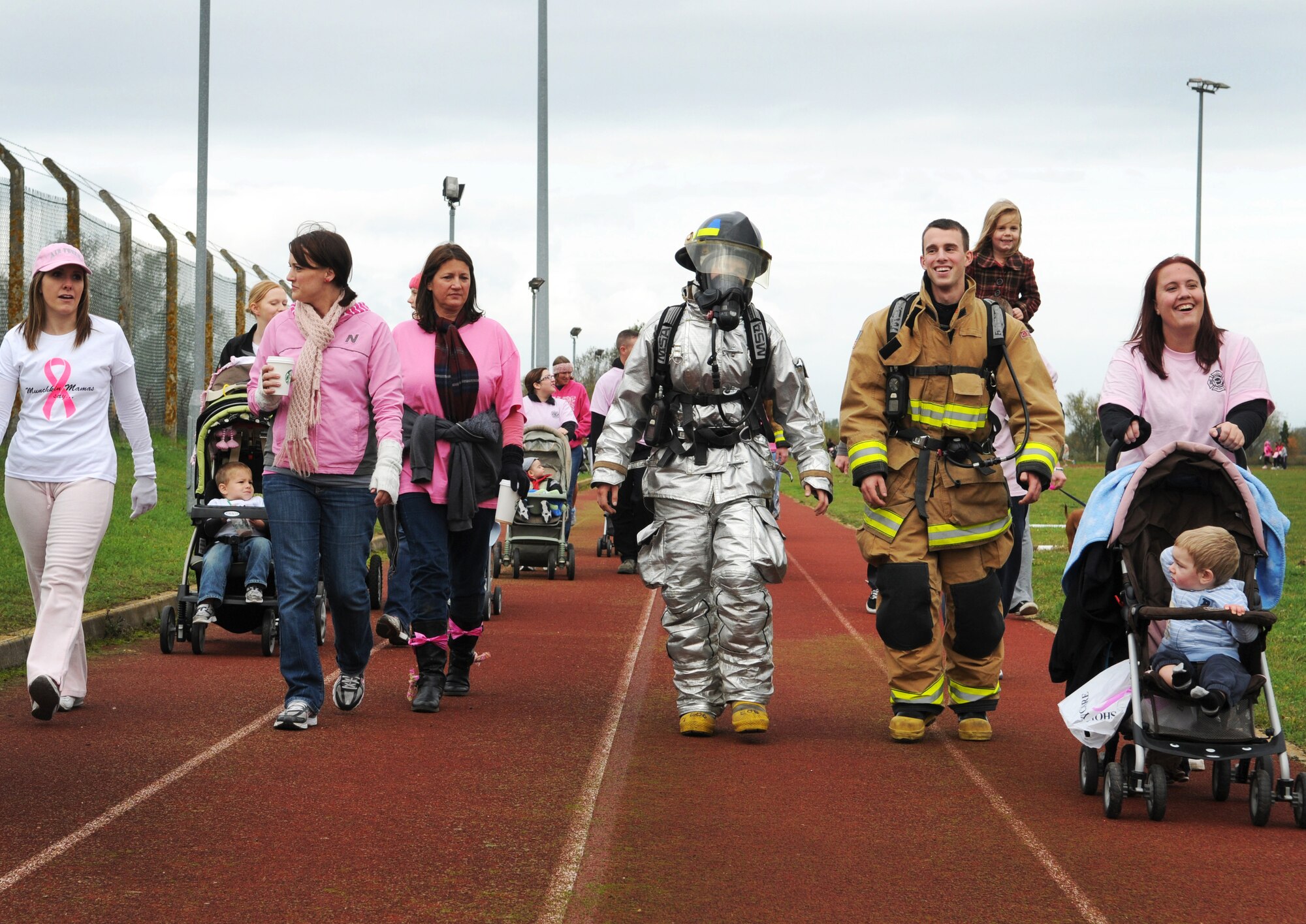 Base members walk the track during the Wear Pink Breast Cancer Awareness 5/10K Walk Oct. 26, 2012, at RAF Mildenhall, England.  The event was organized by the Bob Hope Community Center in support of Breast Cancer Awareness Month.  (U.S. Air Force photo by Staff Sgt. Tabitha M. Lee/Released)