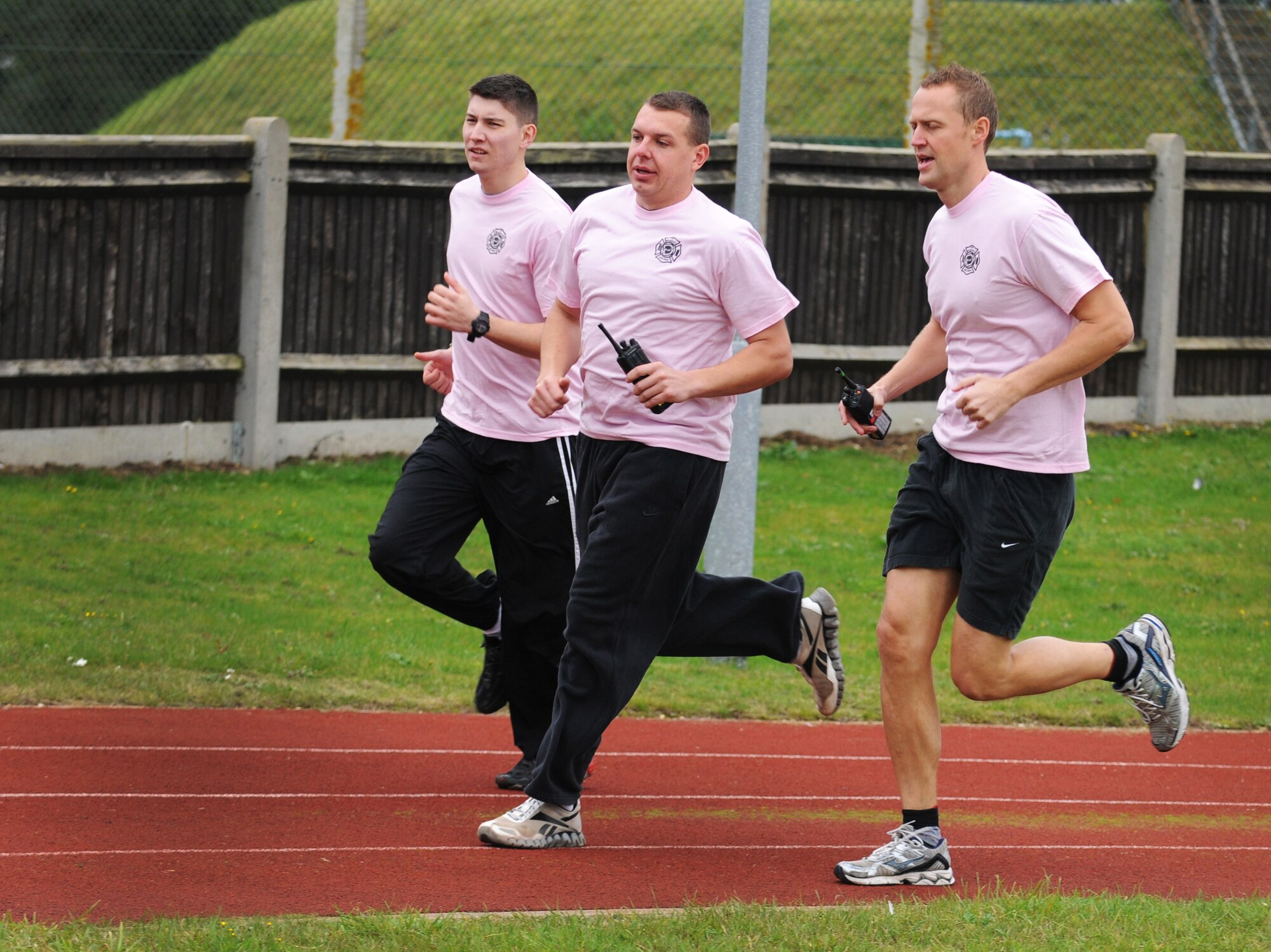 Members of the RAF Mildenhall Fire Department run during the Wear Pink Breast Cancer Awareness 5/10K Walk Oct. 26, 2012, at RAF Mildenhall, England.  Approximately 200 base members came out to the Heritage Park track and ran or walked in support of Breast Cancer Awareness Month.  (U.S. Air Force photo by Staff Sgt. Tabitha M. Lee/Released)