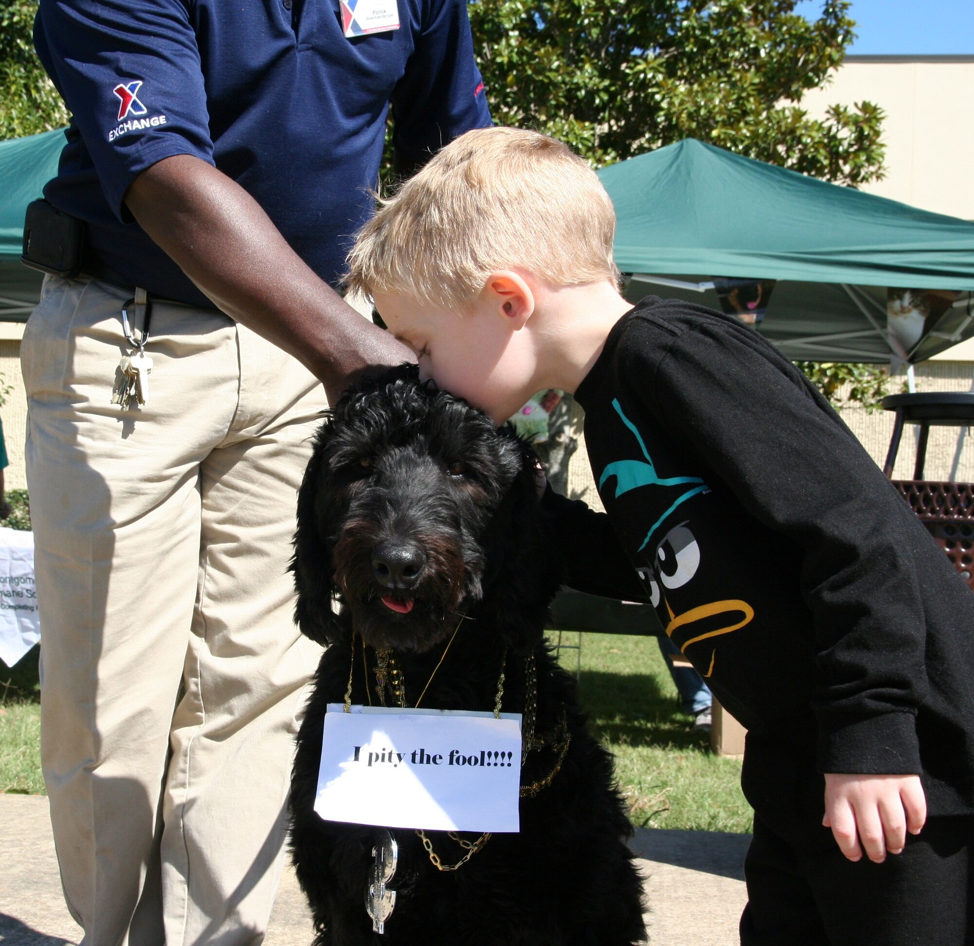 Micah Sheaffer, 5, kisses his dog Franklin Delano during the pet show Saturday at the Maxwell Base Exchange. Franklin dressed up as Mr. T, thanks to owner Tracie Sheaffer, an Air Force spouse. (Courtesy photo)