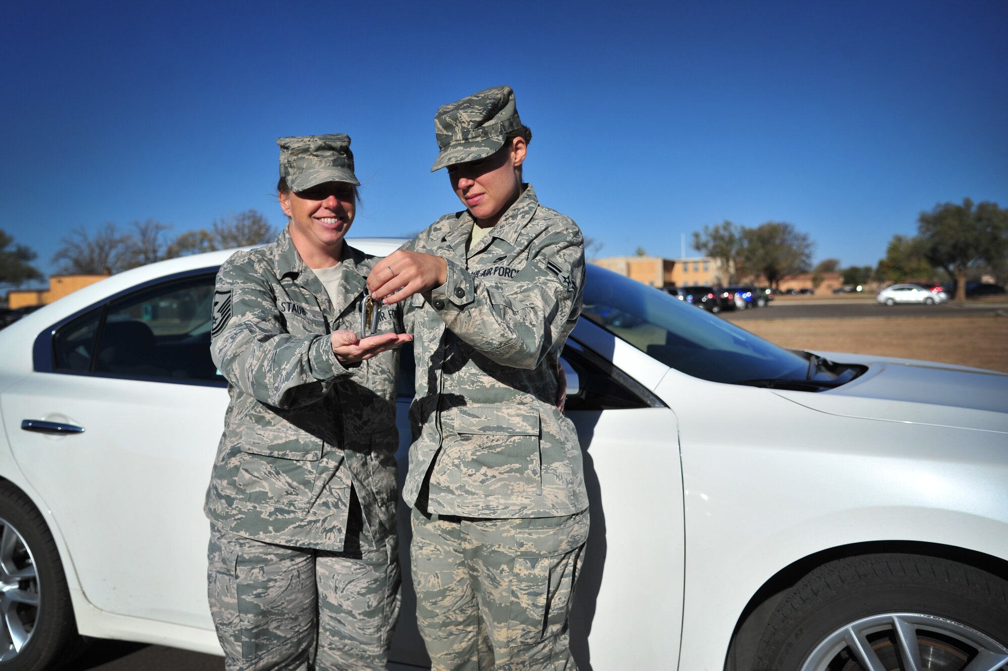 U.S. Air Force Master Sgt. Elizabeth Staub, 27th Special Operations Maintenance Squadron first sergeant, takes keys from Airman 1st Class Rachel Macios, 27 SOMXS, to illustrate the wingman concept at Cannon Air Force Base, N.M., Oct. 25, 2012. First sergeants are an excellent reprisal-free resource to call upon when designated driver plans fall through. (U.S. Air Force illustration/Airman 1st Class Alexxis Pons Abascal)  