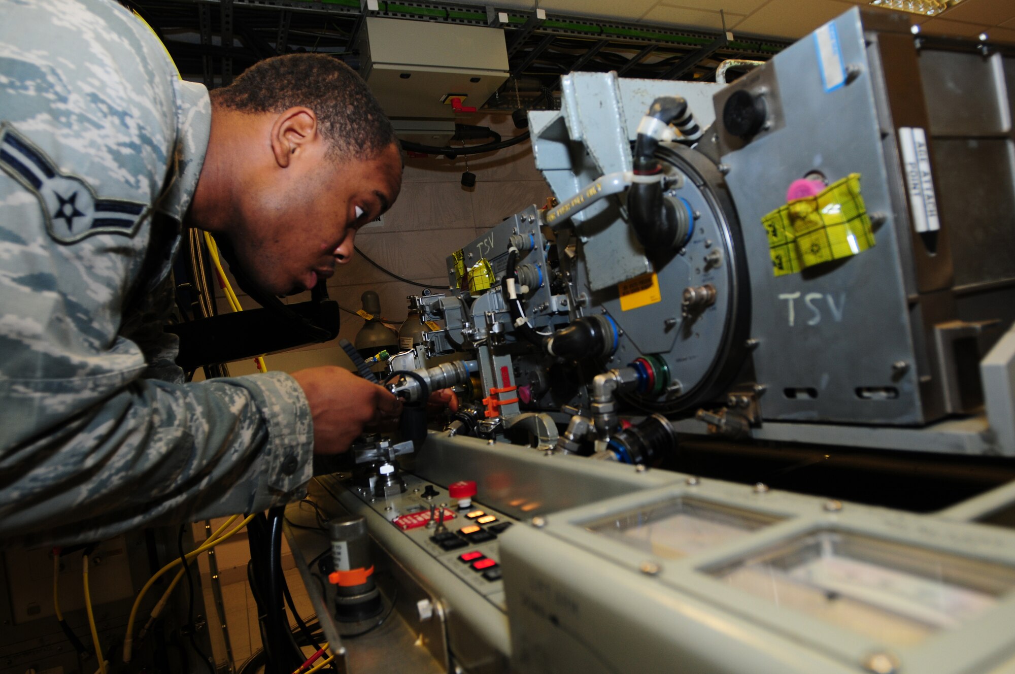 ROYAL AIR FORCE LAKENHEATH, England – Airman 1st Class Samson Lawrence, 48th Component Maintenance Squadron avionics intermediate team member, attaches test cables during testing Oct. 25, 2012. The avionics intermediate shop recently achieved 100% functionality on all test equipment. Airmen from the 48th CMS avionics intermediate section provide highly effective and efficient intermediate support to maintain the electronics on the F-15s. (U.S. Air Force photo by Airman 1st Class Cory D. Payne)