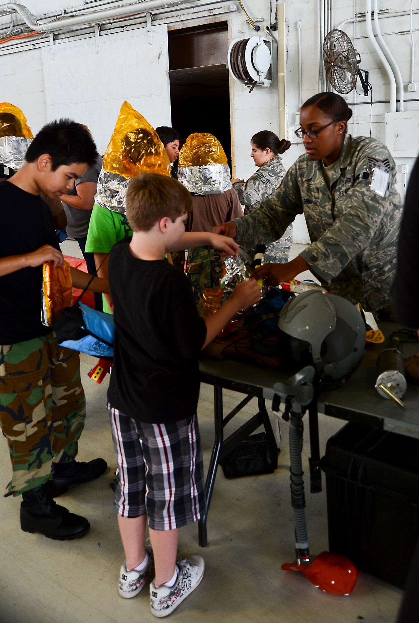 Tech. Sgt. Ria Sonny, 6th Operation Support Squadron aircrew flight equipment craftsman, demonstrates the proper wear of an emergency passenger oxygen system during ROTC Day Oct. 19, 2012, at MacDill Air Force Base, Fla. Coordination between multiple base agencies led to the display of a KC-135 Stratotanker, a security forces marine patrol boat, and a mock deployment tent. (U.S. Air Force photo by Airman 1st Class Melanie Bulow-Kelly/Released)   