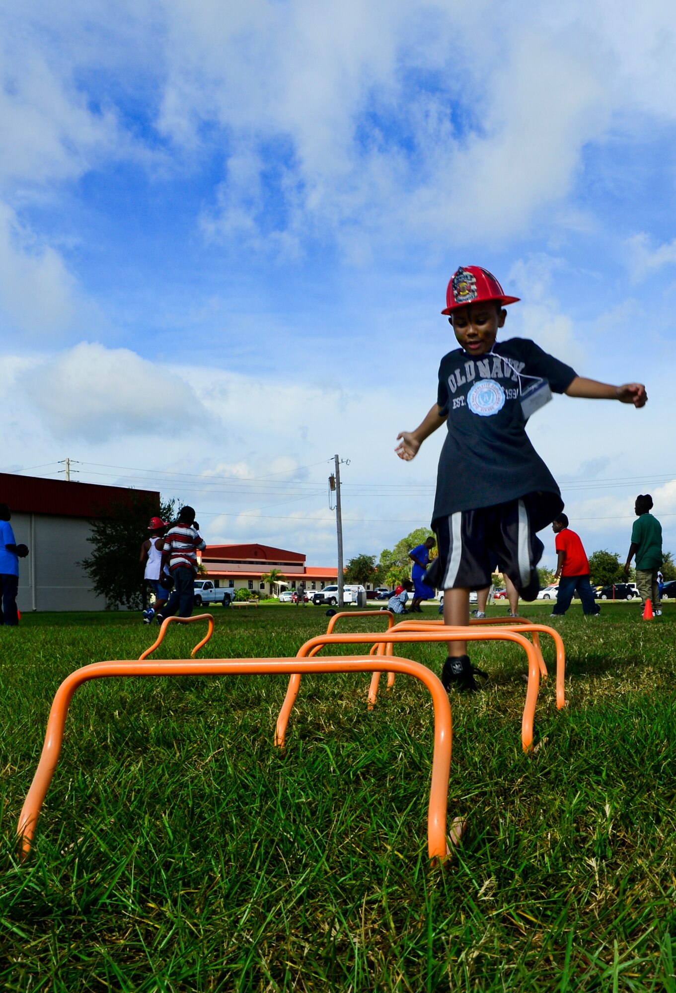 Donavyn, 6, jumps over a hurdle on the obstacle course during Big for a Day  Oct. 19, 2012, at MacDill Air Force Base, Fla. Team MacDill partnered with Big Brothers Big Sisters of Tampa Bay for the annual Big for a Day event where 103 service members volunteered to be “bigs” for 60 children from the Tampa Bay community. (U.S. Air Force photo by Airman 1st Class Melanie Bulow-Kelly/Released)