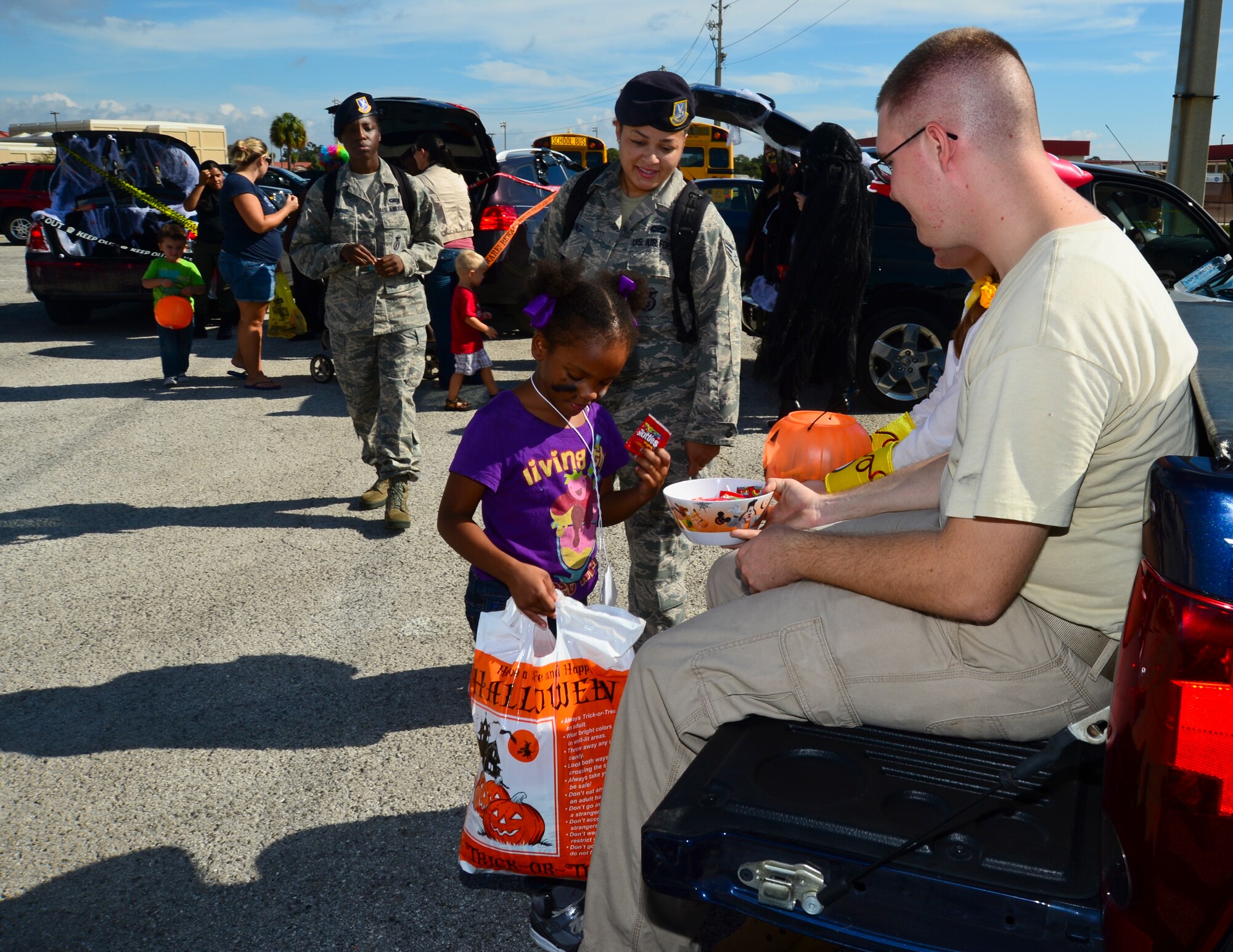 Tadeja, 6, takes a piece of candy during the “trunk or treats” portion of Big for a Day at MacDill Air Force Base, Fla., Oct. 19, 2012. Team MacDill partnered with Big Brothers Big Sisters of Tampa Bay for the annual Big for a Day in which 103 service members volunteered to be “bigs” for 60 children from the Tampa Bay community. (U.S. Air Force photo by Airman 1st Class Melanie Bulow-Kelly/Released)
