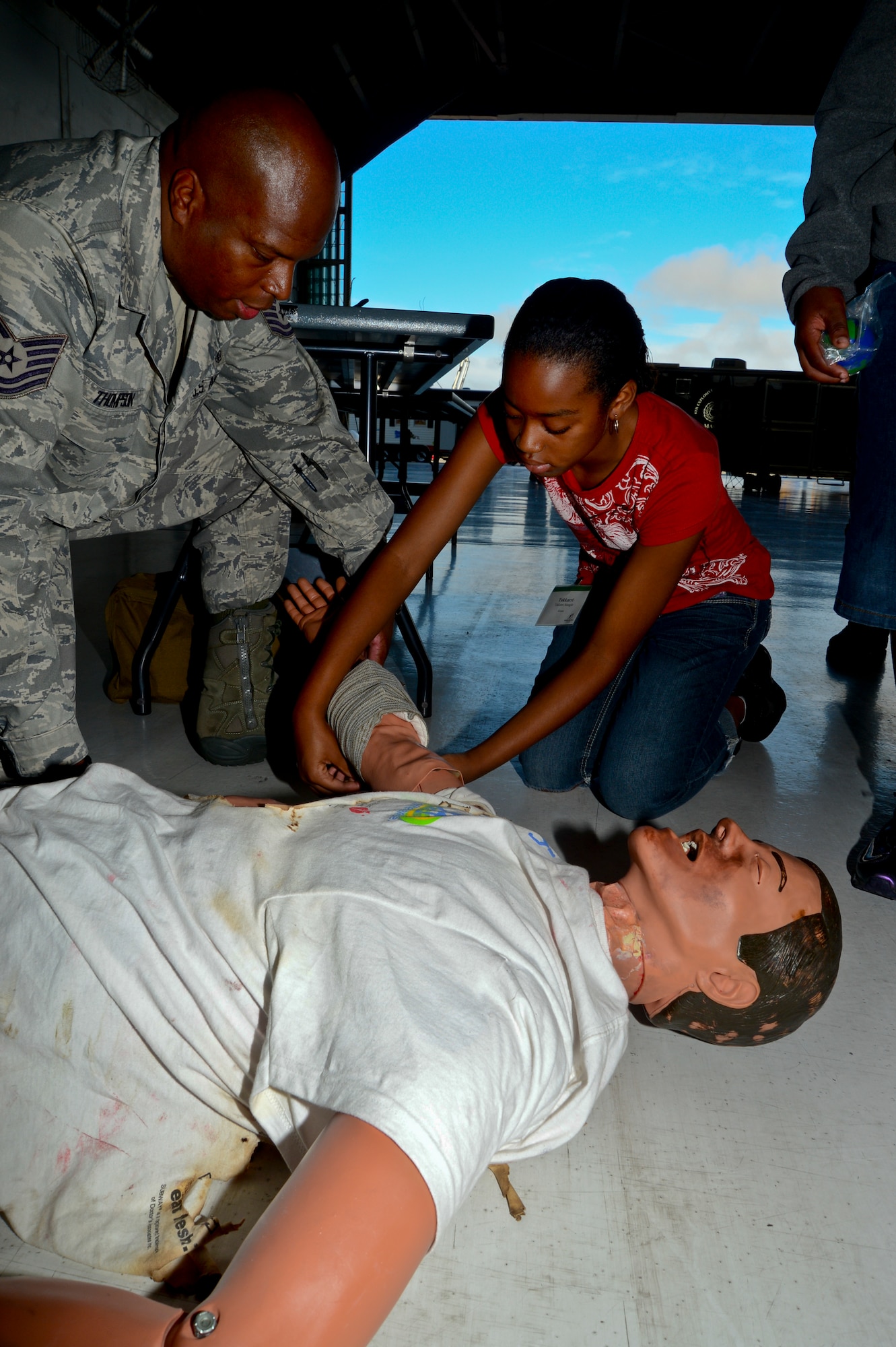 Tech. Sgt. Malcolm Thompson, 6th Medical Group medic, shows Takkarri, 11, how to wrap a wound during Big for a Day, Oct. 19, 2012, at MacDill Air Force Base, Fla. Team MacDill partnered with Big Brothers Big Sisters of Tampa Bay for the annual Big for a Day event; 103 service members volunteered to be “bigs” for 60 children from the Tampa Bay community. (U.S. Air Force photo by Airman 1st Class Melanie Bulow-Kelly/Released)