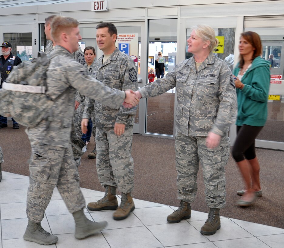 WRIGHT-PATTERSON AIR FORCE BASE, Ohio – Senior Airman Garrick Payne, 87th Aerial Port Squadron air transportation craftsman, is greeted by friends and co-workers at the Dayton International Airport Oct. 25 after returning from a six-month deployment to Southwest Asia where he was assigned to the 379th Air Expeditionary Wing. (U.S. Air Force photo/Stacy Vaughn)