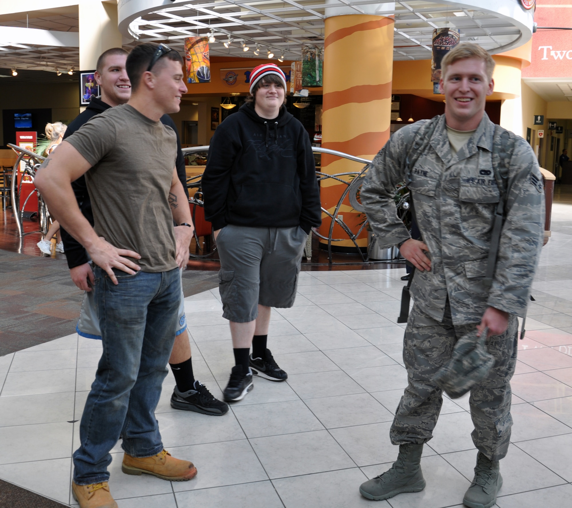 WRIGHT-PATTERSON AIR FORCE BASE, Ohio – Friends and co-workers greet Senior Airman Garrick Payne, 87th Aerial Port Squadron air transportation craftsman, at the Dayton International Airport Oct. 25. Payne was deployed for six months with the 379th Air Expeditionary Wing, Southwest Asia. (U.S. Air Force photo/Stacy Vaughn) 