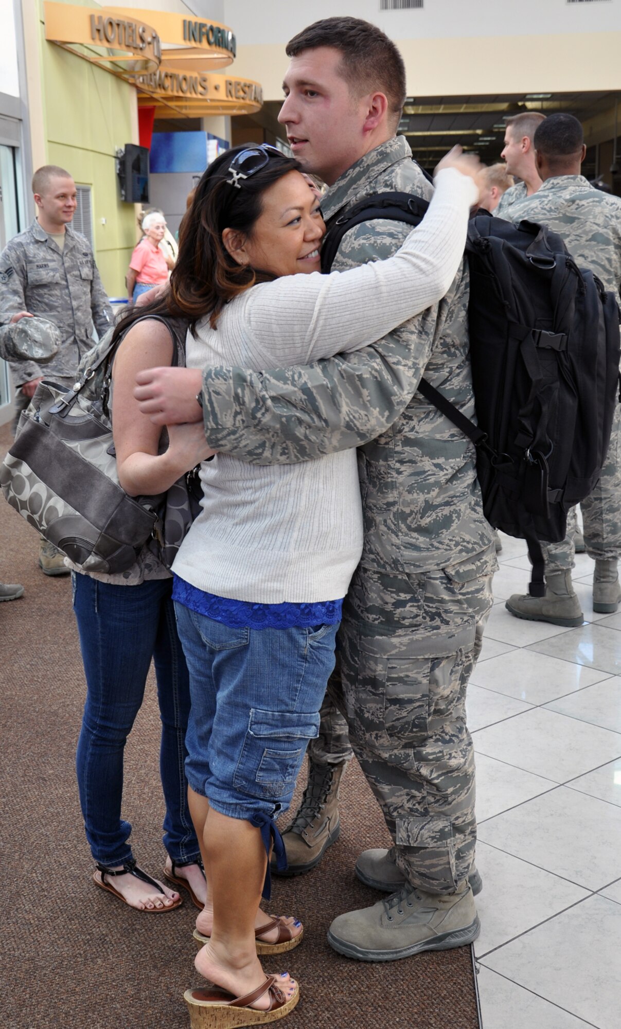 WRIGHT-PATTERSON AIR FORCE BASE, Ohio – Senior Airman Nick Harvey, 445th Aircraft Maintenance Squadron information knowledge management journeyman, is greeted by friends and co-workers at the Dayton International Airport Oct. 25 after returning from a six-month deployment to Southwest Asia where he was assigned to the 379th Air Expeditionary Wing. (U.S. Air Force photo/Stacy Vaughn)