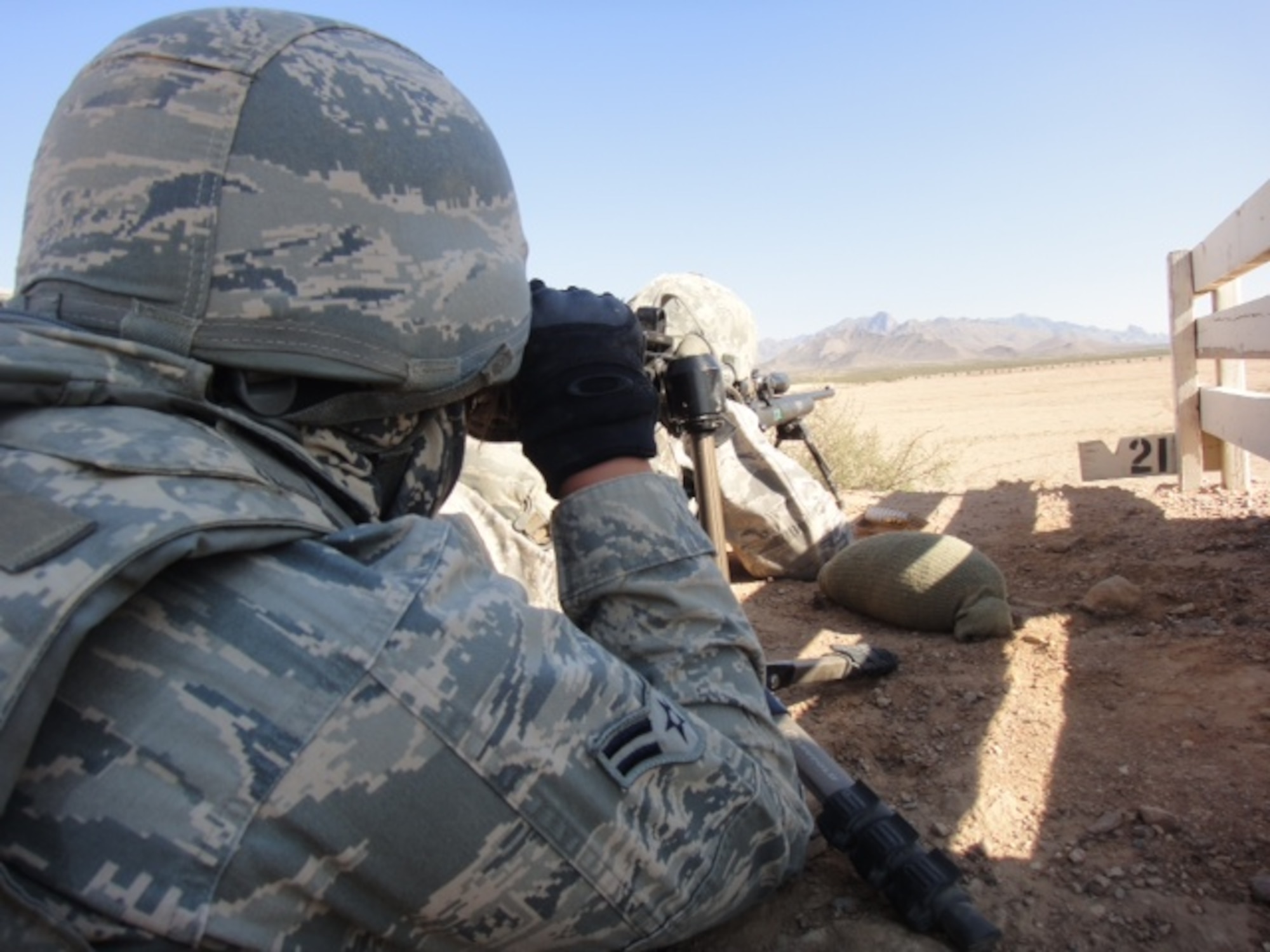 Airman 1st Class Tiffani Potter, 14th Security Forces Squadron spots for Jesse Janda, 14th SFS during a field shooting exercise. Potter and Janda became sniper-certified Sept. 21, making it possible for other Airmen at Columbus Air Force Base to seek their own certification. (Courtesy Photo)
