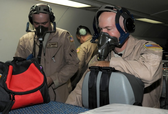 SOUTHWEST ASIA - U.S. Air Force Majs. Ryan Ough, 970th Expeditionary Airborne Air Control Squadron senior director, and Victor Walk, 970th EAACS air surveillance officer, test their oxygen masks on board an E-3 Sentry before a training flight Oct. 24, 2012. The 970th EAACS here currently consists primarily of Airmen from its home station, Tinker Air Force Base, Okla. (U.S. Air Force photo/Tech. Sgt. Amanda Savannah)