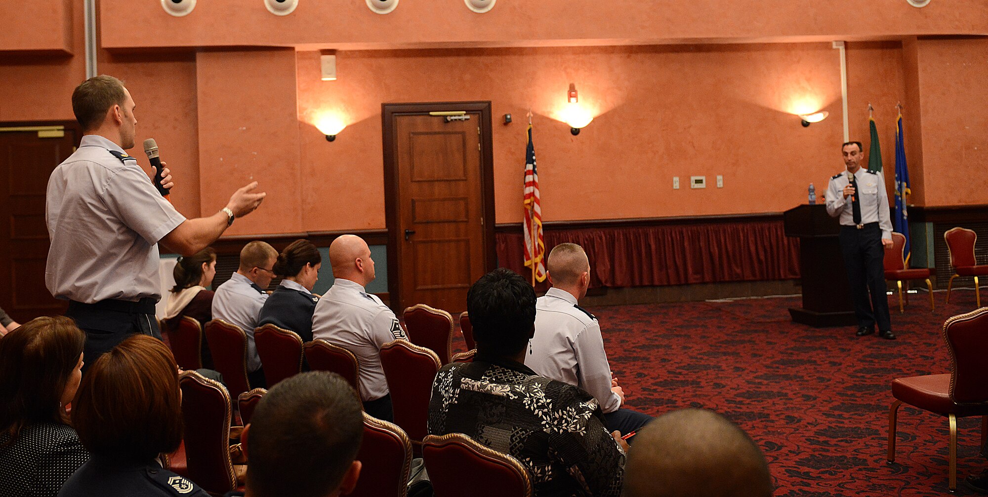 Maj. Gerremy Goldsberry, 31st Fighter Wing program manager, asks Brig. Gen. Scott Zobrist, 31st FW commander, a question during a town hall meeting held Oct. 22 at the La Bella Vista Club at Aviano Air Base, Italy. To make the town hall more accessible, Team Aviano members could attend the town hall, listen to it aired live on American Forces Network Aviano, or recieve updates via Facebook.  (U.S. Air Force photo by Senior Airman Katherine Tereyama)
