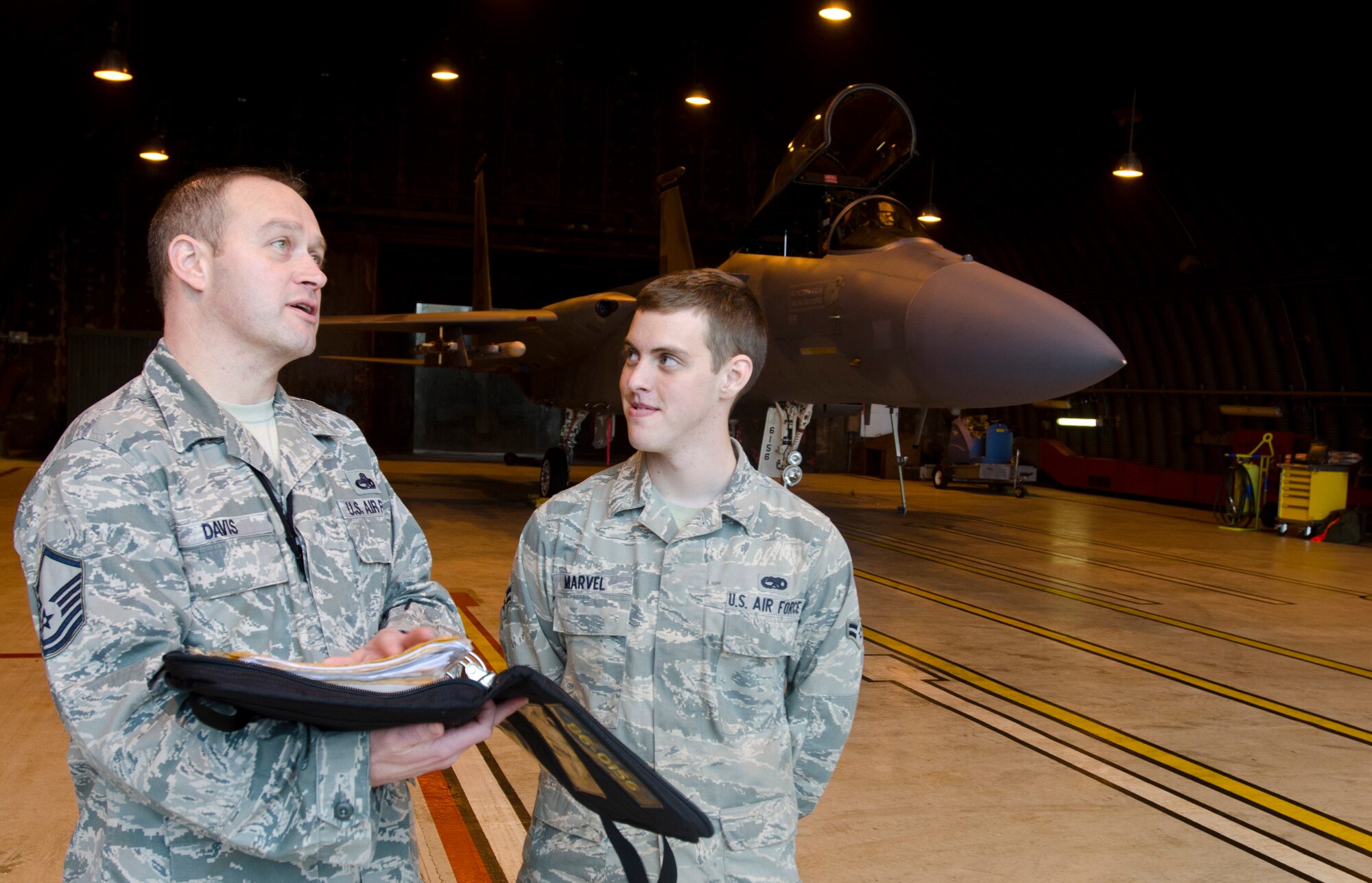ROYAL AIR FORCE LAKENHEATH, England - Master Sgt. Christopher Davis, 493rd Aircraft Maintenance Unit lead production superintendent and native of Grenada, Miss., talks with Airman 1st Class Brandon Marvel, 748th AMXS assistant dedicated crew chief and native of Taylor, Mich., at a permanent aircraft shelter Oct. 23, 2012. Davis was recently awarded the Gen. Lew Allen Jr. Trophy. The trophy is awarded annually to a base-level officer and senior NCO in the aircraft, munitions or missile maintenance fields directly involved in sortie generation. (U.S. Air Force photo by Staff Sgt. Stephen Linch)