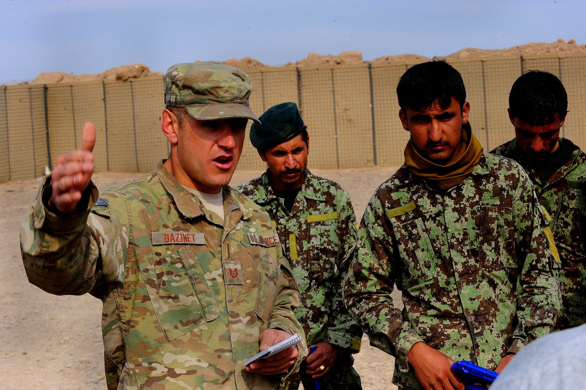U.S. Air Force Tech. Sgt. Dwayne Bazinet, Security Forces advisor, gives a debrief to Afghan AF Security Forces members after their field training exercise, Oct. 18, 201,2 at Shindand Air Base, Afghanistan. This was an initial security and tactical training culmination exercise for the Shindand Air Wing Security Forces. (U.S. Air Force photo/ Tech. Sgt. Quinton Russ/RELEASED)