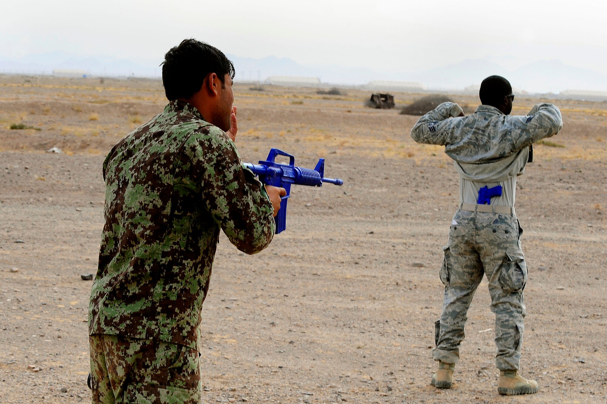 Afghan Air Force Security Forces Solider Said Ahmad yells out commands to U.S. AF Senior Airman Brandon Warren to left up his jacket during a field training exercise, Oct. 18, 2012, at Shindand Air Base, Afghanistan. This was an initial security and tactical training culmination exercise for the Shindand Air Wing Security Forces. (U.S. Air Force photo/ Tech. Sgt. Quinton Russ/RELEASED)