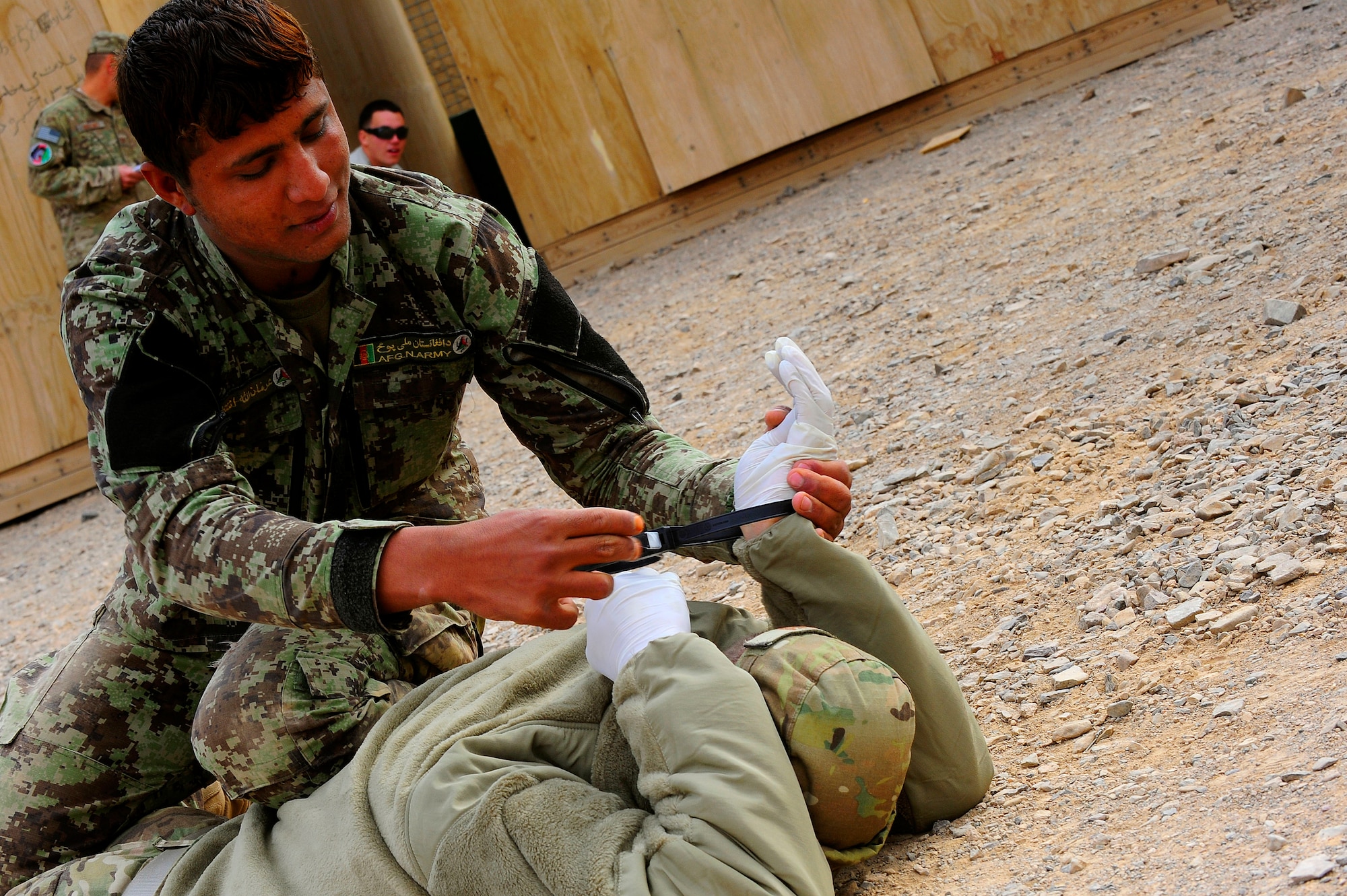Afghan Air Force Security Forces Soldier Noor Alam practices handcuffing an U.S. Air Force Security Forces member during field training exercise, Oct. 18, 2012 at Shindand Air Base, Afghanistan. This was an initial security and tactical training culmination exercise for the Shindand Air Wing Security Forces. (U.S. Air Force photo/ Tech. Sgt. Quinton Russ/RELEASED)