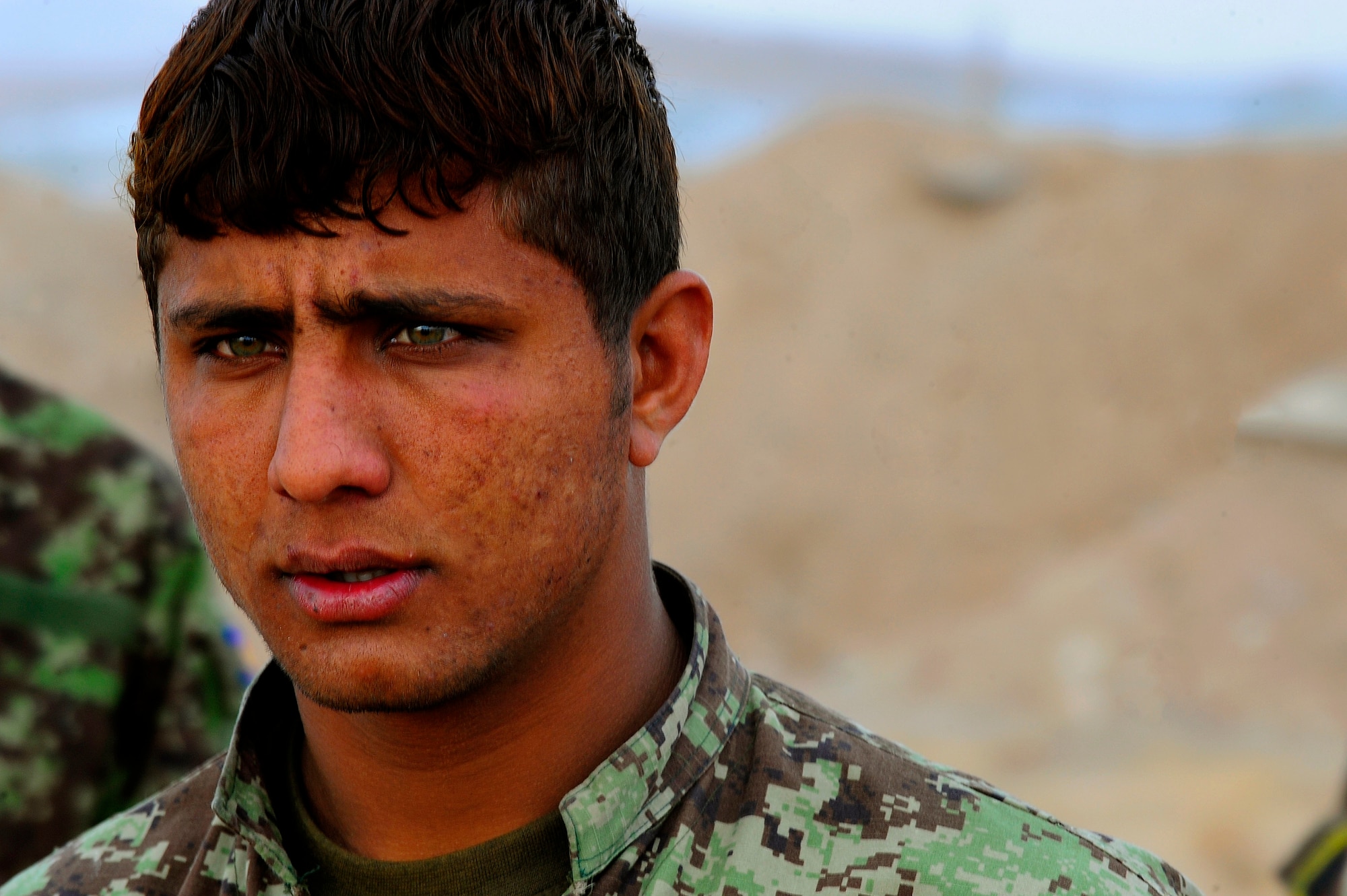 Afghan Air Force Security Forces Soldier Noor Alam listens to the debrief of a field training exercise, Oct. 18, 2012, at Shindand Air Base, Afghanistan. This was an initial security and tactical training culmination exercise for the Shindand Air Wing Security Forces. (U.S. Air Force photo/ Tech. Sgt. Quinton Russ/RELEASED)
