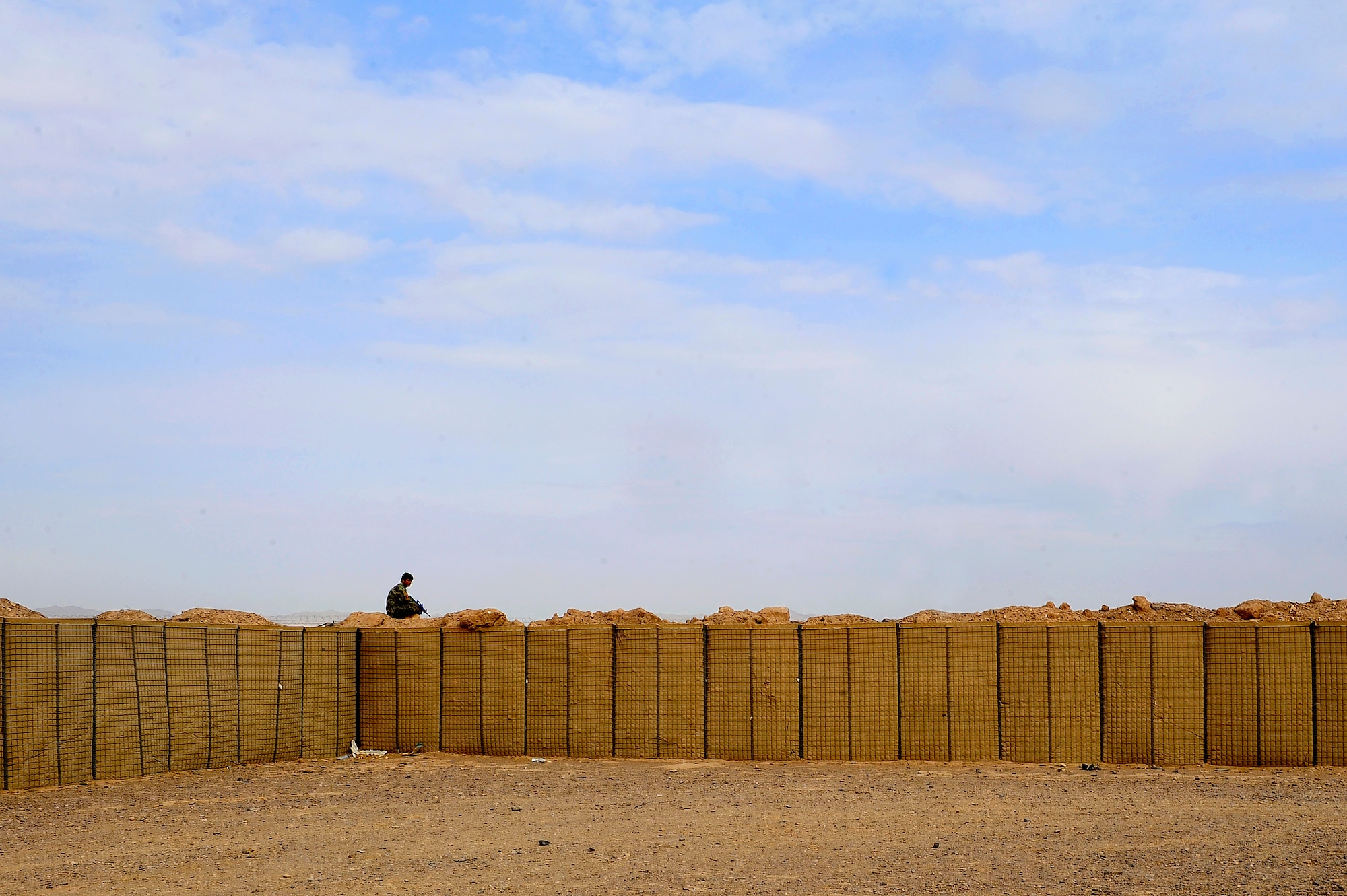 Afghan Air Force Solider Qasim, top, stands lookout during a field training exercise, Oct. 18, 2012, at Shindand Air Base, Afghanistan. This was an initial security and tactical training culmination exercise for the Shindand Air Wing Security Forces. (U.S. Air Force photo/ Tech. Sgt. Quinton Russ/RELEASED)