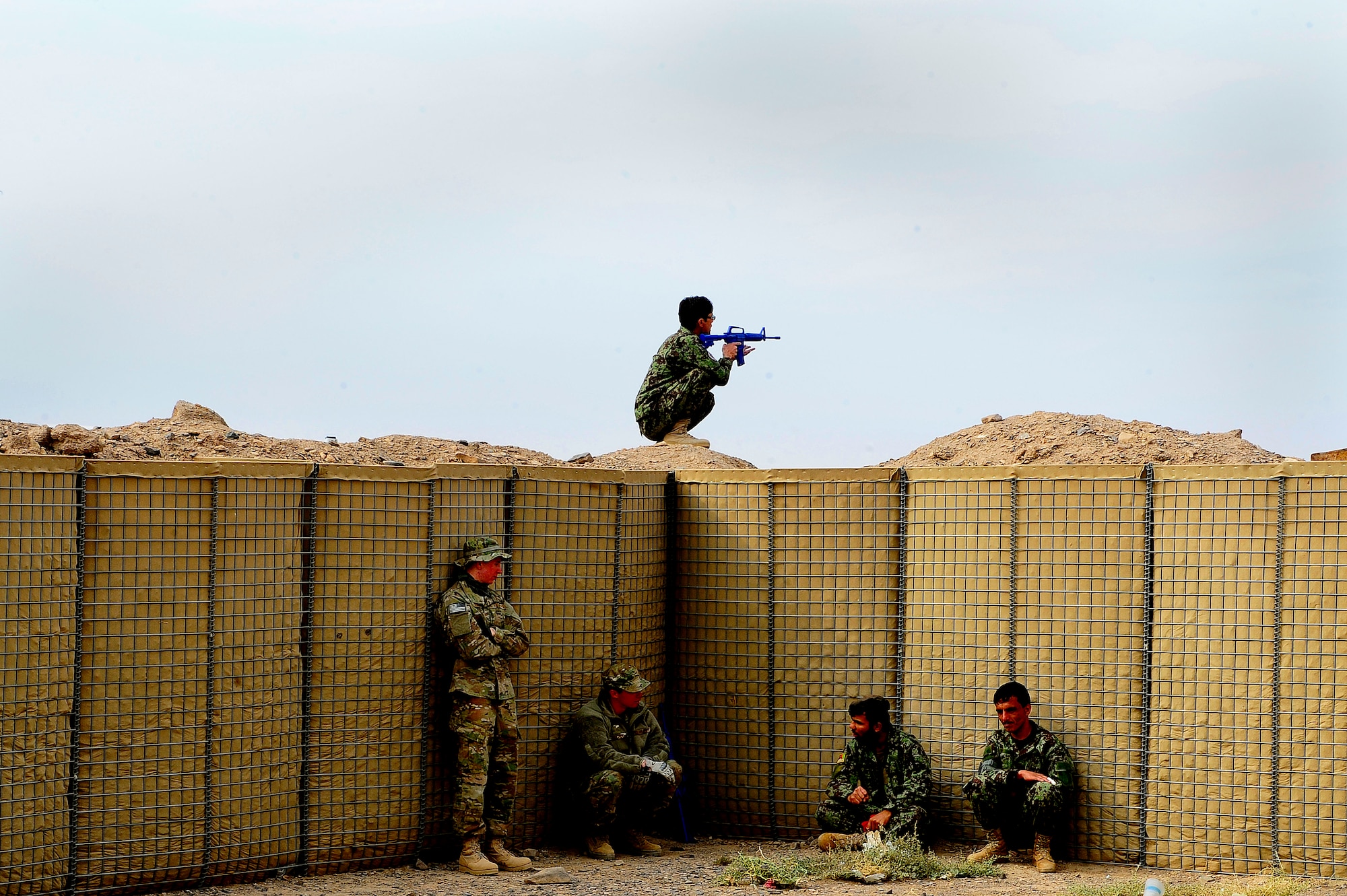 Afghan Air Force Solider Qasim, top, stands lookout during a field training exercise, Oct. 18, 2012, at Shindand Air Base, Afghanistan. This was an initial security and tactical training culmination exercise for the Shindand Air Wing Security Forces. (U.S. Air Force photo/ Tech. Sgt. Quinton Russ/RELEASED)