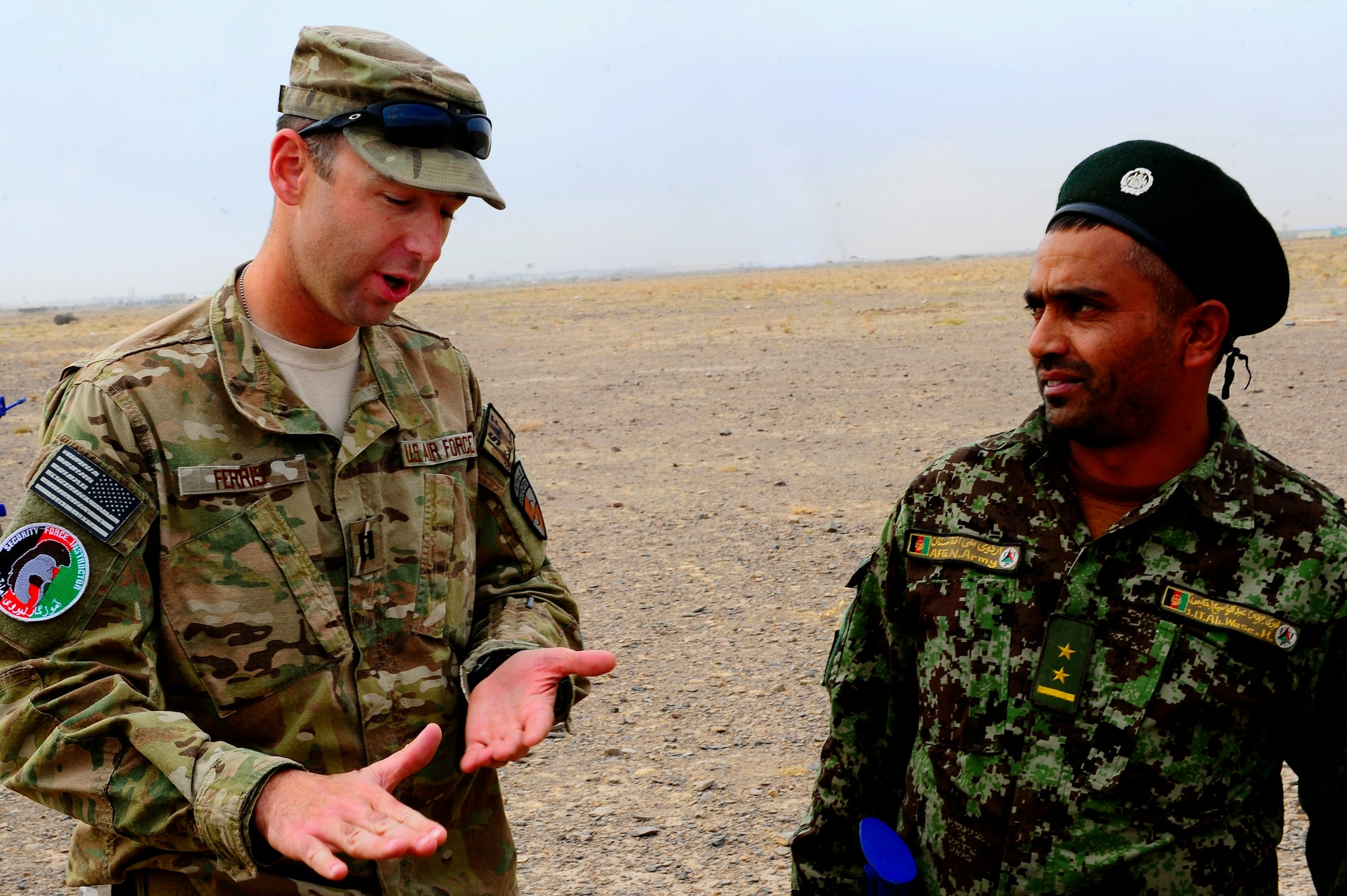 U.S. Air Force Capt. Phillip Ferris, advisor, talks with Afghan AF Lt. Abdul Wasi about different tactics during field training, Oct. 18, 2012, at Shindand Air Base, Afghanistan. This was an initial security and tactical training culmination exercise for the Shindand Air Wing Security Forces. (U.S. Air Force photo/ Tech. Sgt. Quinton Russ/RELEASED)