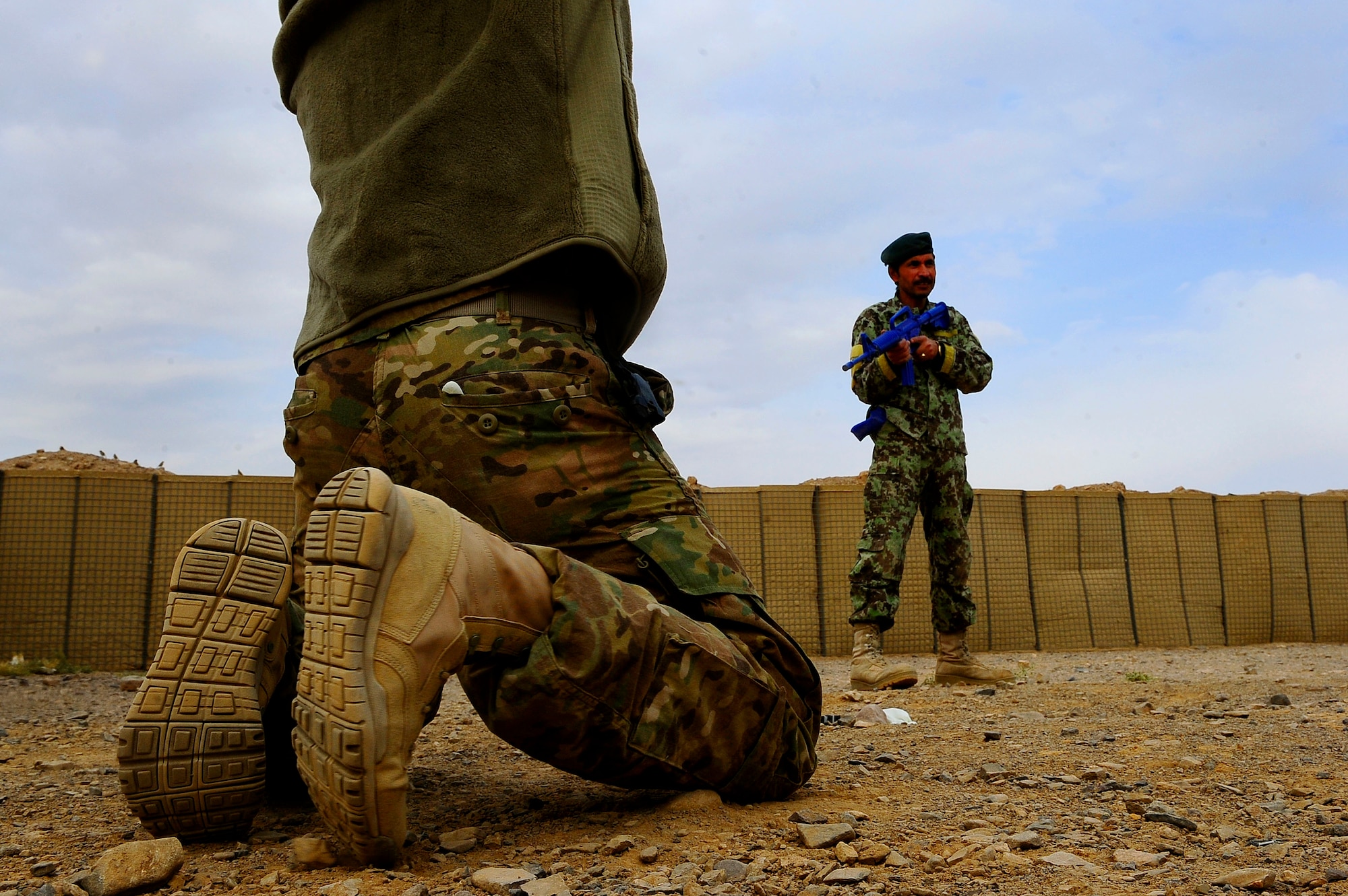 Afghan Air Force Security Forces Solider Sadigullah stands watch over a person of interest during field training, Oct. 18, 2012 at Shindand Air Base, Afghanistan. This was an initial security and tactical training culmination exercise for the Shindand Air Wing Security Forces. (U.S. Air Force photo/ Tech. Sgt. Quinton Russ/RELEASED)