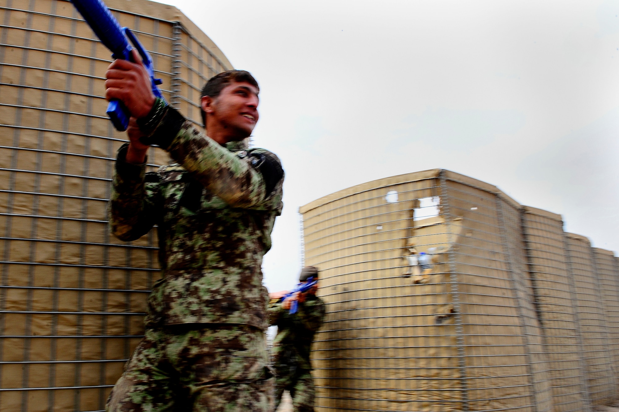 Afghan Air Force Security Forces Soldier Noor Alam clears a corner of a simulated village during field training, Oct. 18, 2012, at Shindand Air Base, Afghanistan. This was an initial security and tactical training culmination exercise for the Shindand Air Wing Security Forces. (U.S. Air Force photo/ Tech. Sgt. Quinton Russ/RELEASED)