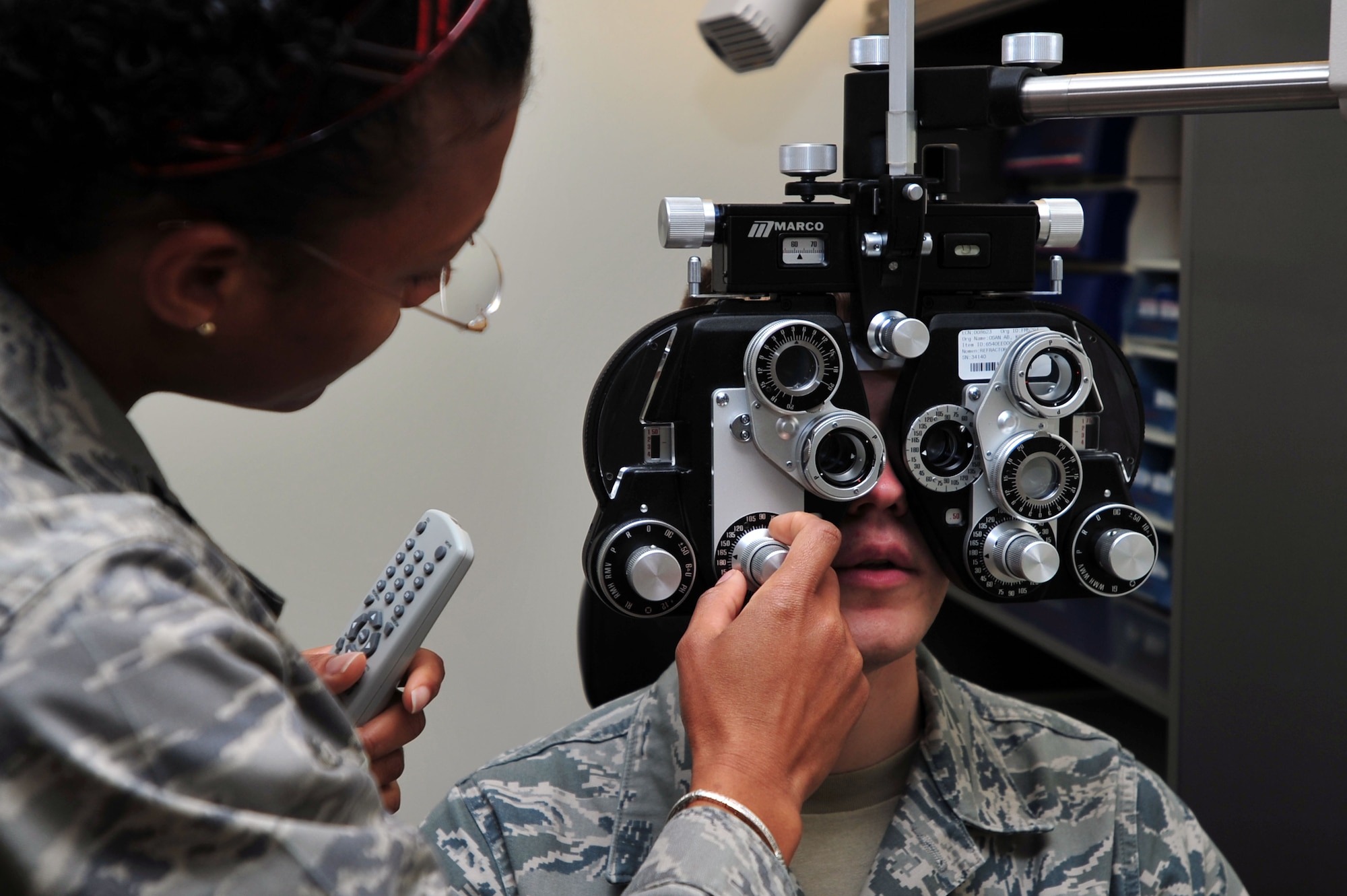 Capt. Felicia Jackson, 51st Aerospace Medicine Squadron Optometry Flight optometrist, conducts an eye exam at Osan Air Base, Republic of Korea, Oct. 24, 2012. The optometry flight provides optic care for the base populous keeping everyone fit to fight. The team of four includes two optometrists and two ophthalmic technicians. (U.S. Air Force photo/Airman 1st Class Alexis Siekert)