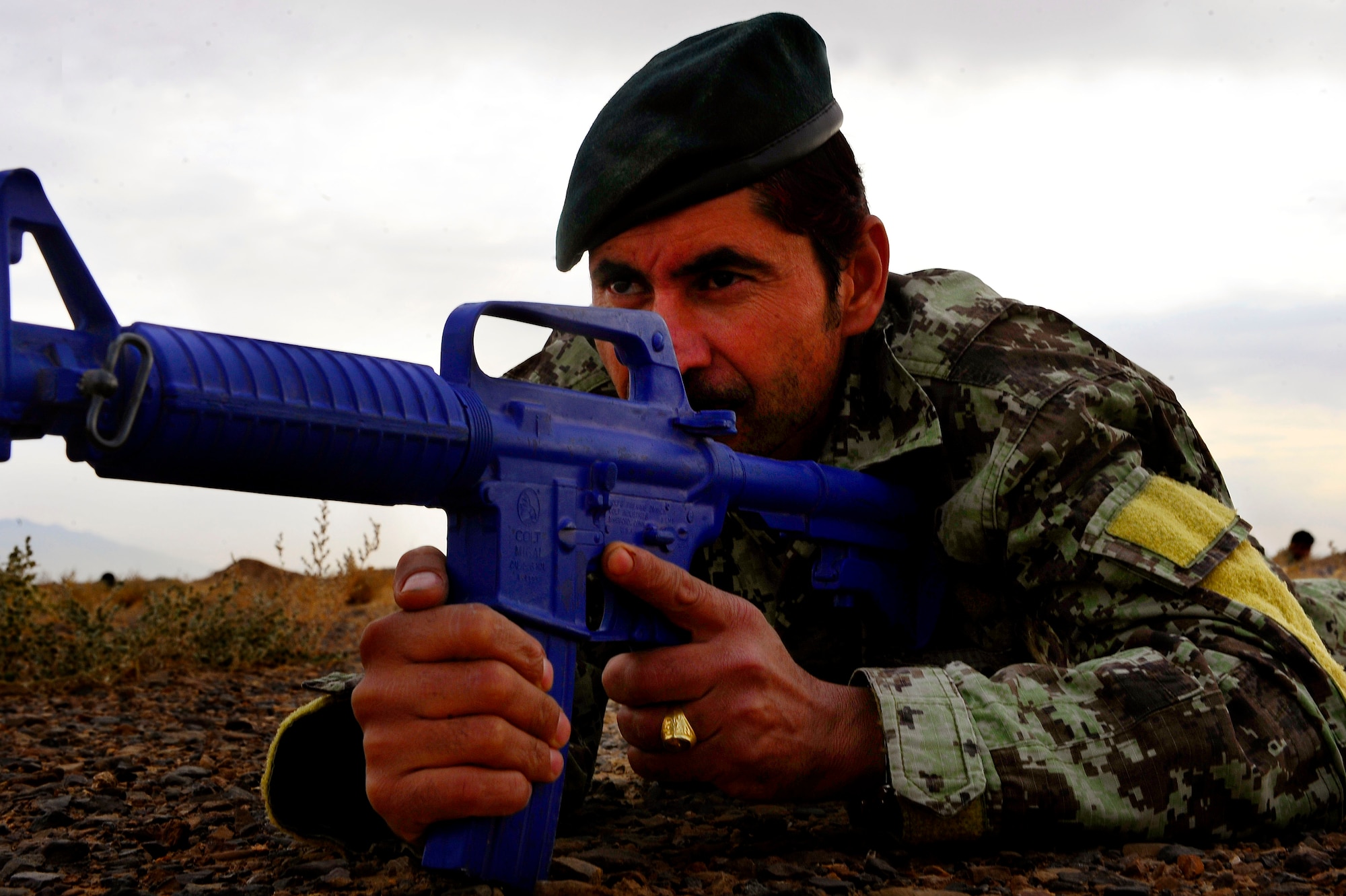 Afghan Air Force Security Forces Solider Sadigullah goes prone after a simulated attack during an 81st Security Forces Kandak field training exercise, Oct. 18, 2012, at Shindand Air Base, Afghanistan. This was an initial security and tactical training culmination exercise for the Shindand Air Wing Security Forces. (U.S. Air Force photo/ Tech. Sgt. Quinton Russ/RELEASED)