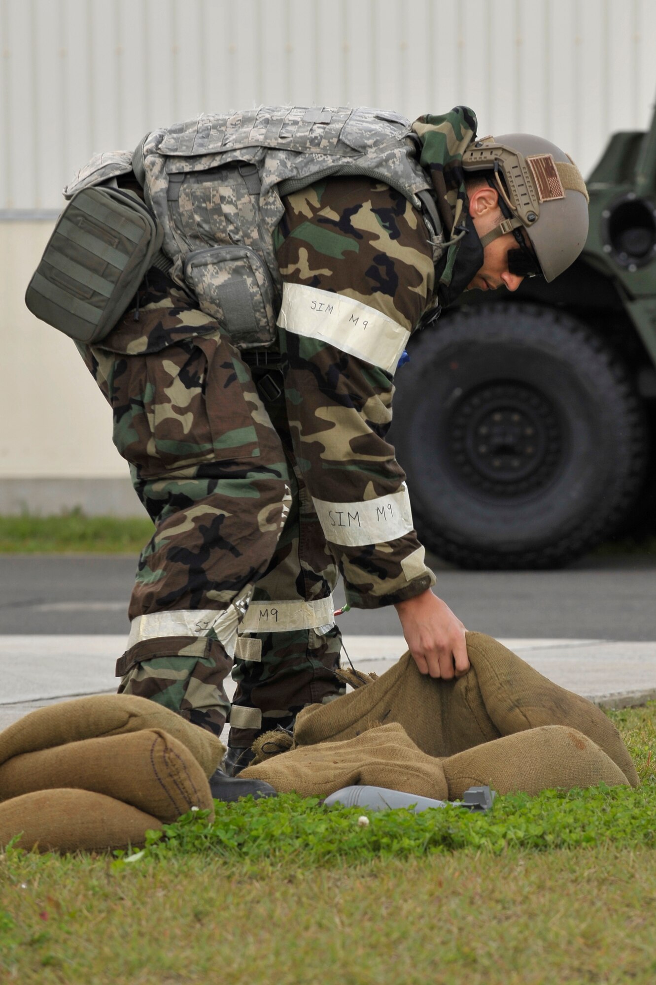 U.S. Air Force Senior Airman William Holliday, 35th Civil Engineer Squadron explosive ordinance disposal technician, stacks sandbags around an unexploded ordinance mock up during a Prime Base Engineer Emergency Forces exercise at Misawa Air Base, Japan, Oct. 18, 2012.  Monthly exercises, like this simulated mortar attack, keep Airmen from the 35 CES ready for their wartime mission. (U.S. Air Force photo by Staff Sgt. Nathan Lipscomb)