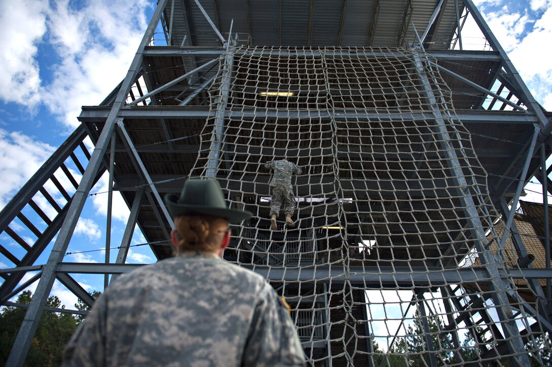 Army Sgt. Serina Glass instruct a private negotiating the "Victory Tower" on Fort Jackson, S.C., Oct. 25, 2012. The tower is  a military obstacle course designed to build personal confidence in new Army recruits. Glass, is a drill sergeant, is assigned to Company E, 1st Battalion, 61st Infantry Regiment.