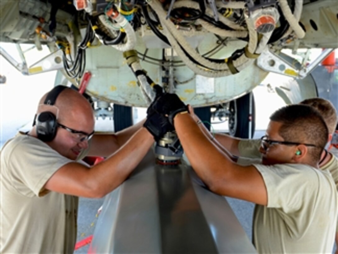 Senior Airman Daniel Babis, left, and Airman 1st Class Anthony Rodriguez attach an umbilical connector to a training AGM-86B conventional air-launched cruise missile during a B-52 Stratofortress load demonstration at Andersen Air Force Base, Guam, on Oct. 17, 2012.  Babis and Rodriguez are 36th Expeditionary Aircraft Maintenance Squadron weapons load technicians deployed from the 96th Expeditionary Aircraft Maintenance Unit, Barksdale Air Force Base, La.  