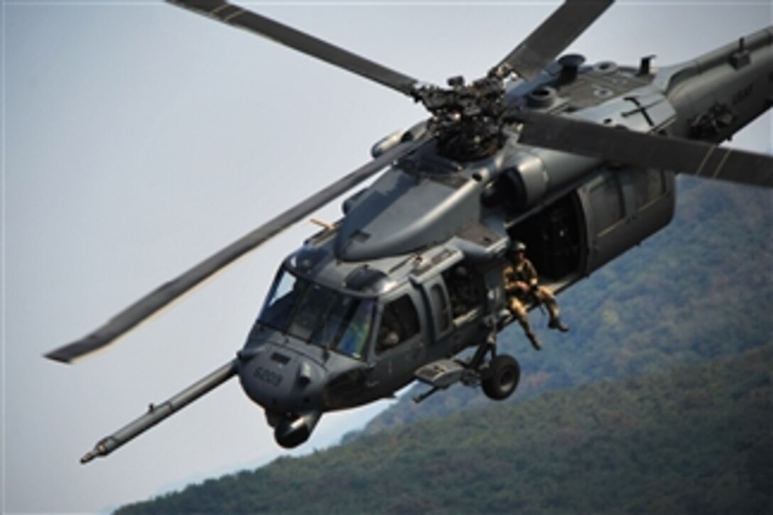 Crewmembers of the 33rd Rescue Squadron fly an HH-60G Pave Hawk over Osan Air Base, South Korea, on Oct. 20, 2012.  The squadron participated in an air show to help highlight the relationship between the U.S. service members and South Korea through public demonstrations of military equipment and personnel.  