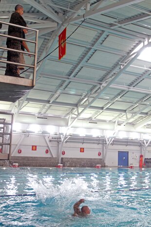 Recruits of Company I, 3rd Recruit Training Battalion, dive into a pool after being taught safe techniques aboard Marine Corps Recruit Depot San Diego Oct. 22. Diving safely was one technique of many recruits learned during a swim qualification course during recruit training. Recruits also learned how to quickly take off a rifle and pack while under water. 