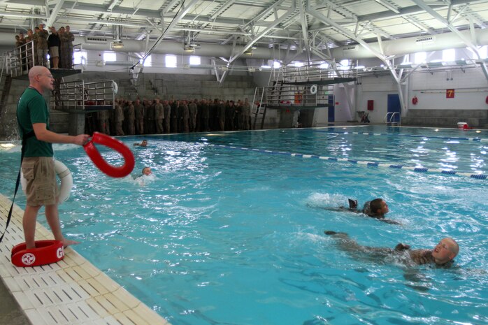 Recruits of Company I, 3rd Recruit Training Battalion, swim to safety after diving into a pool aboard Marine Corps Recruit Depot San Diego Oct. 22. Marine swimming instructors handed flotation devices to any recruits struggling to stay afloat. The exercise was part of a swim qual qualification that all recruits must pass before becoming Marines.