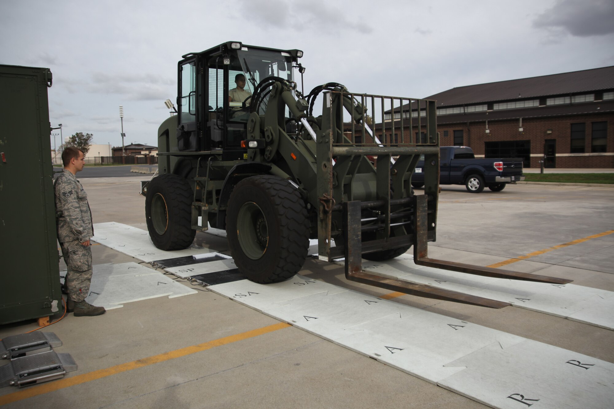 Airman 1st Class Victor Covarrubiasruiz, 305th Aerial Port Squadron cargo processor, drives a 10k all-terrain fork lift over a scale to get center balance weight and height Oct. 27, 2012, at Joint Base McGuire-Dix-Lakehurst, N.J. Weighing and measuring empty vehicles helps the 305th APS members get accurate information from the scale when cargo is being carried.

(U.S. Air Force photo by 2nd Lt. David J. Murphy/Released)