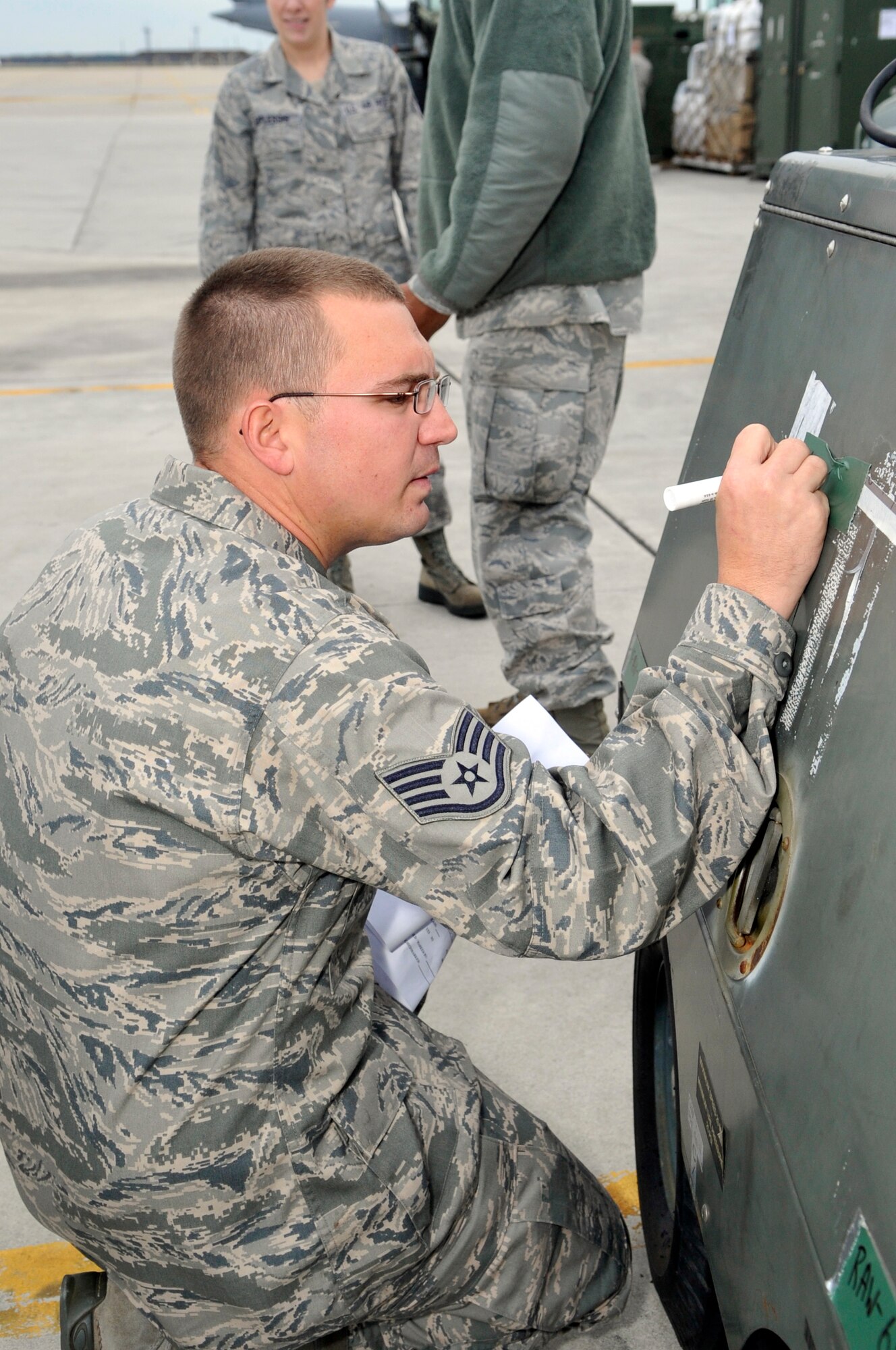 Staff Sgt. Christopher West, 818th Global Mobility Squadron aerial transportation specialist, helps pre-stage cargo by marking the weight of it just before a joint inspection is performed on the cargo needed for aircraft evacuation due to Hurricane Sandy Oct. 26, 2012 at Joint Base McGuire-Dix-Lakehurst. Cole hails from St. Petersburg, Fla. 
(U.S. Air Force photo by Wayne Russell/Released)