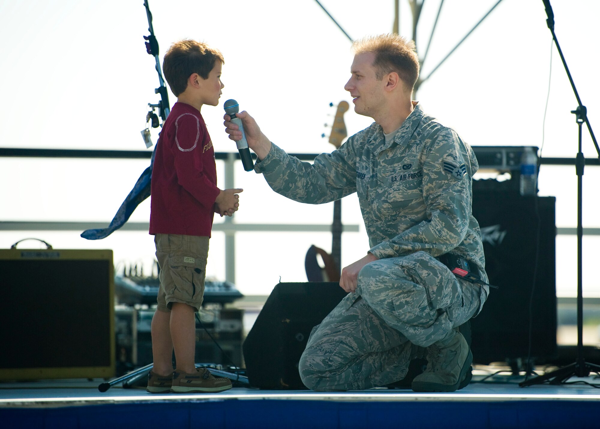 Senior Airman Joe W. McFadden, 1st Special Operations Public Affairs, asks a child a question during Hurlburt Fieldís Open House at the flightline at Hurlburt Field, Fla., Oct. 27, 2012. The Open House gave the public an inside look at Hurlburt Fieldís many missions and allowed Team Hurlburt to show appreciation to the local community for their continued support to the base. (U.S. Air Force photo/Tech. Sgt. Vanessa Valentine)(Released)
